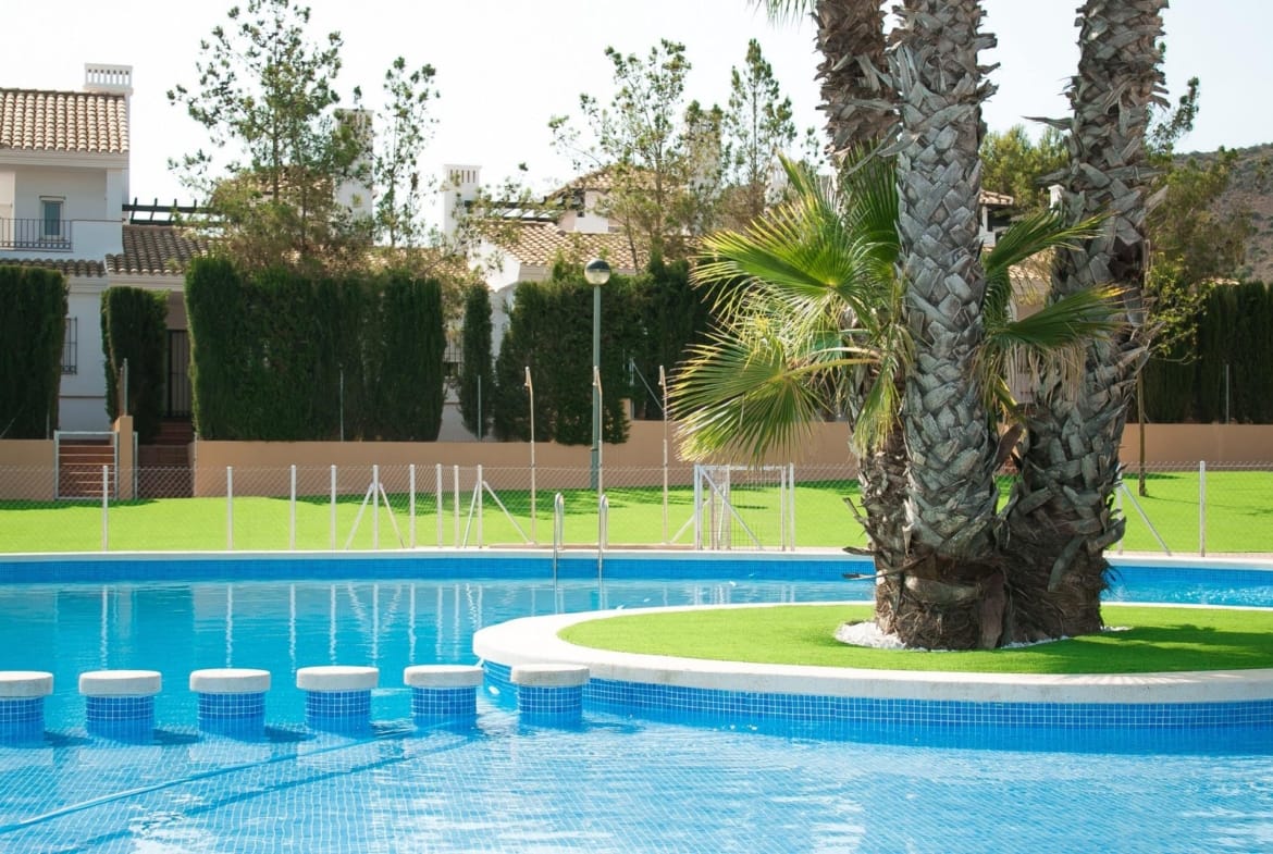 Communal pool with a palm-planted island and stepping stones in Las Palas, Fuente Álamo, Murcia