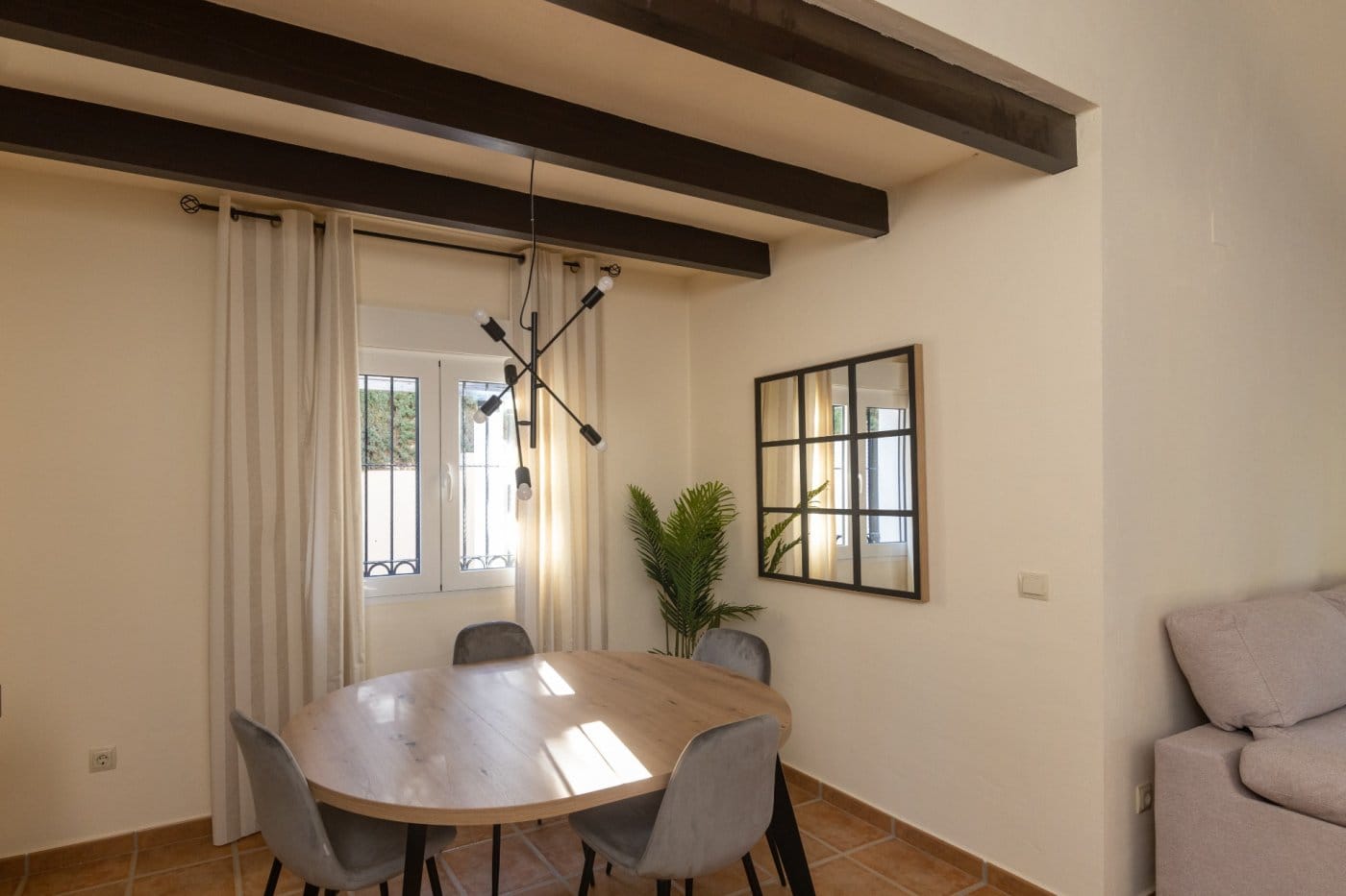 KEY-READY-VILLA-IN-FUENTE-ALAMO-MURCIA-31 Dining table beside a curtained window and wall mirror in Las Palas, Fuente Álamo, Murcia