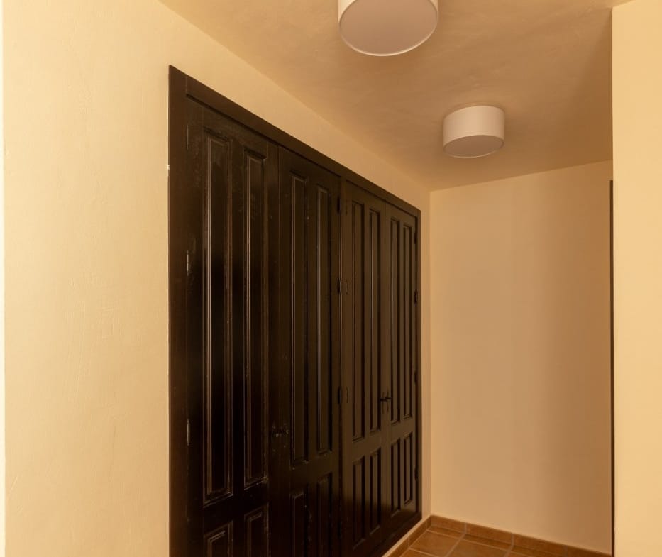 Dressing area with dark fitted wardrobes and tiled flooring in Las Palas, Fuente Álamo, Murcia