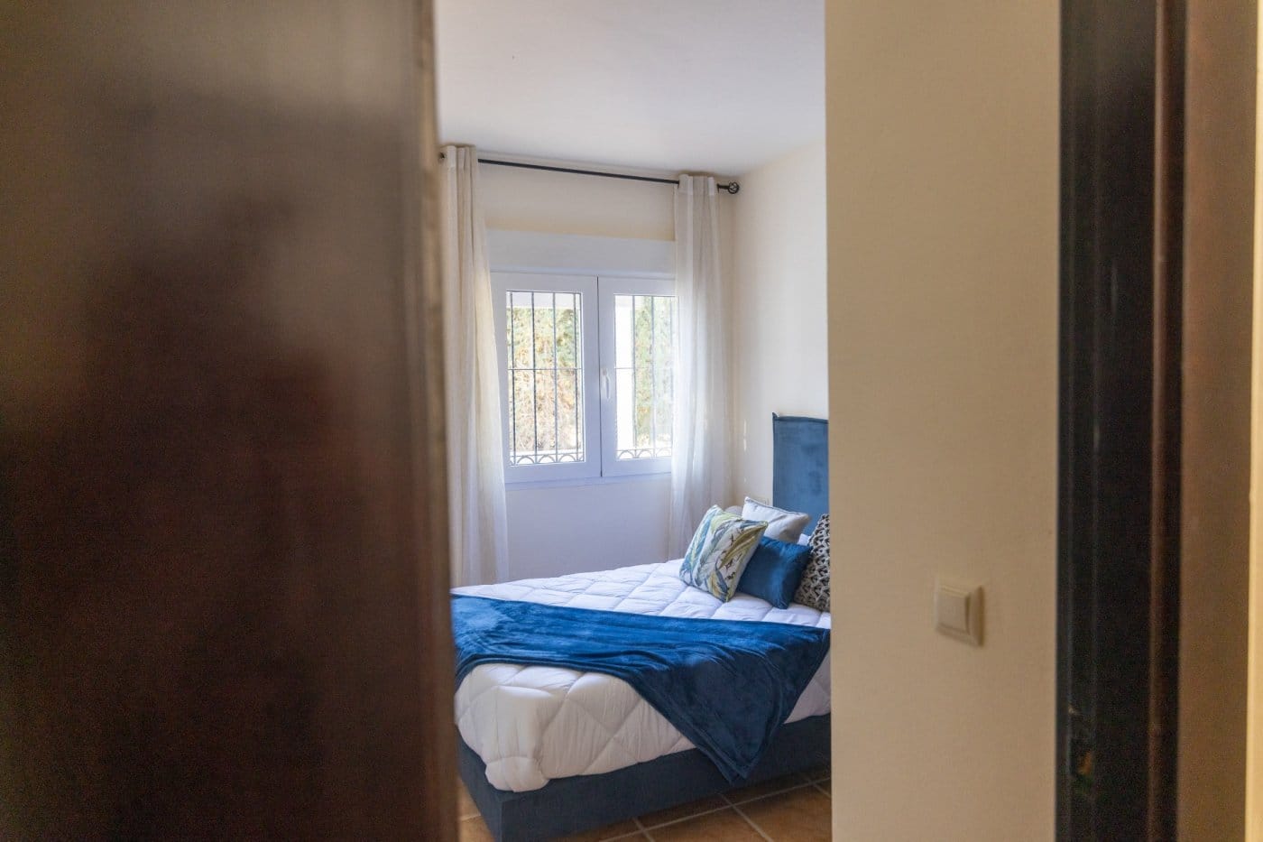 KEY-READY-VILLA-IN-FUENTE-ALAMO-MURCIA-37 Double bedroom with blue bedding viewed through a doorway in Las Palas, Fuente Álamo, Murcia