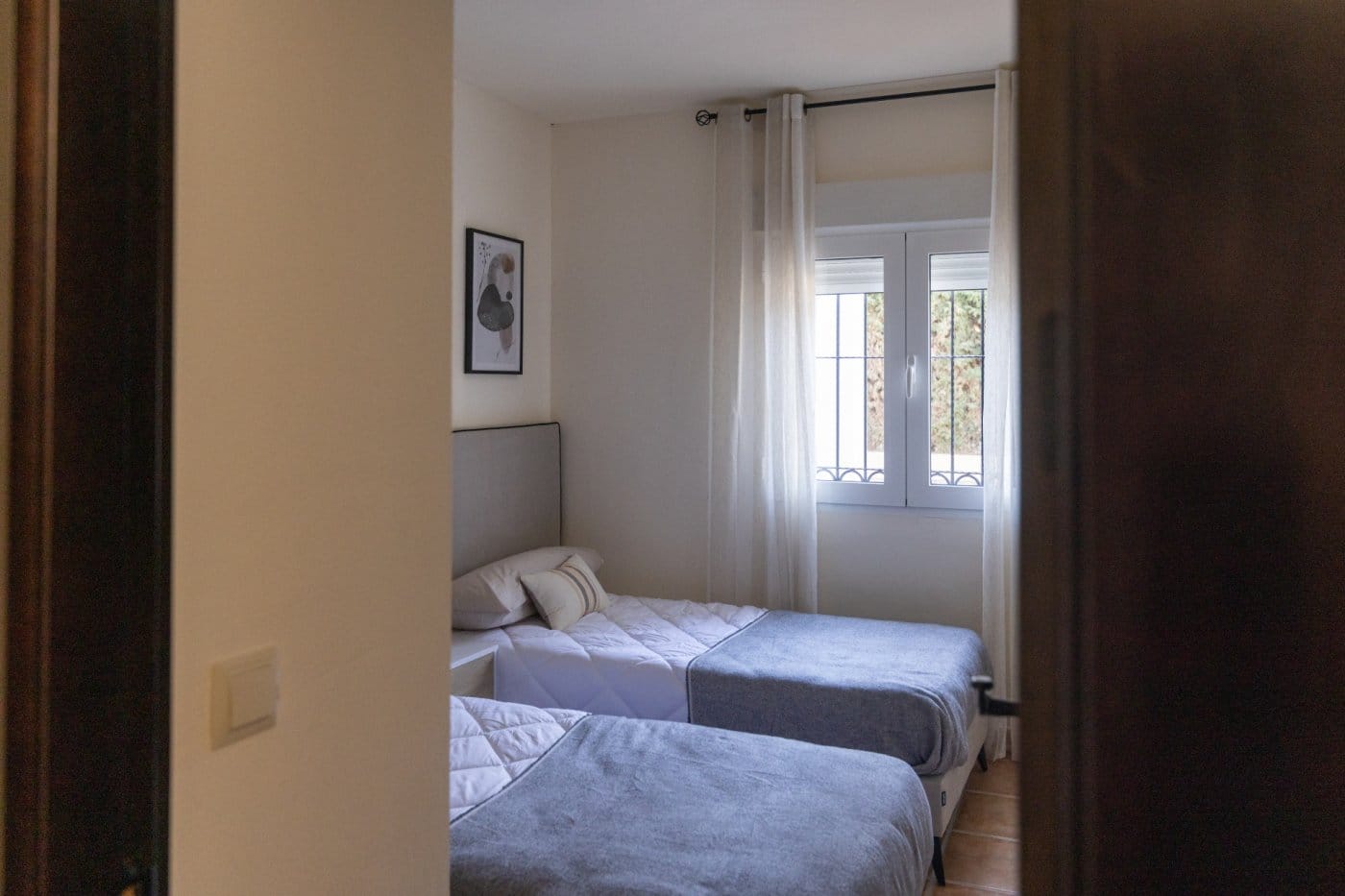 KEY-READY-VILLA-IN-FUENTE-ALAMO-MURCIA-37 Twin bedroom viewed through a wooden doorway in Las Palas, Fuente Álamo, Murcia