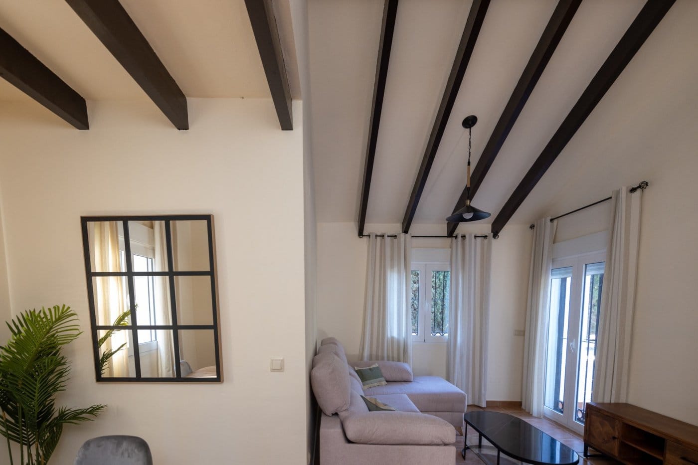 KEY-READY-VILLA-IN-FUENTE-ALAMO-MURCIA-6 Lounge seating beside glazed doors and a wall mirror in Las Palas, Fuente Álamo, Murcia
