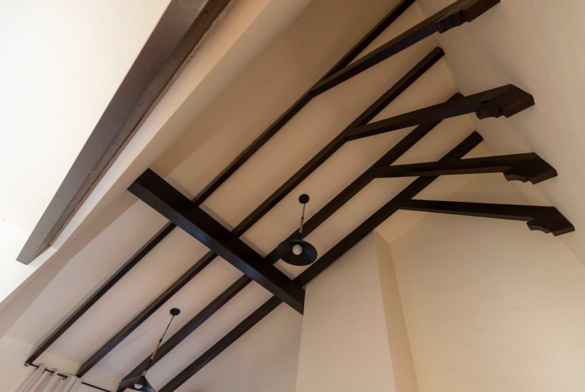 Vaulted ceiling with dark timber beams and a hanging light in Las Palas, Fuente Álamo, Murcia