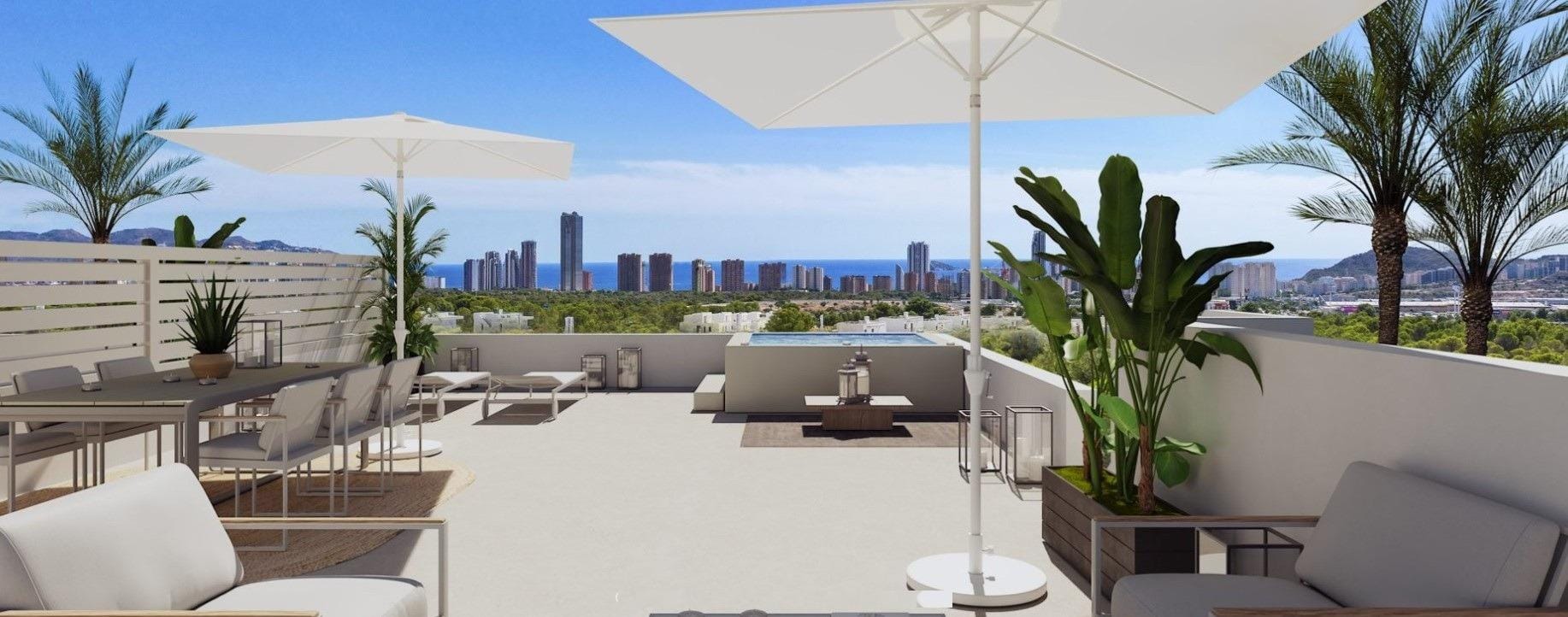 Sunny rooftop terrace with outdoor dining, loungers and umbrellas in Sierra Cortina, Alicante