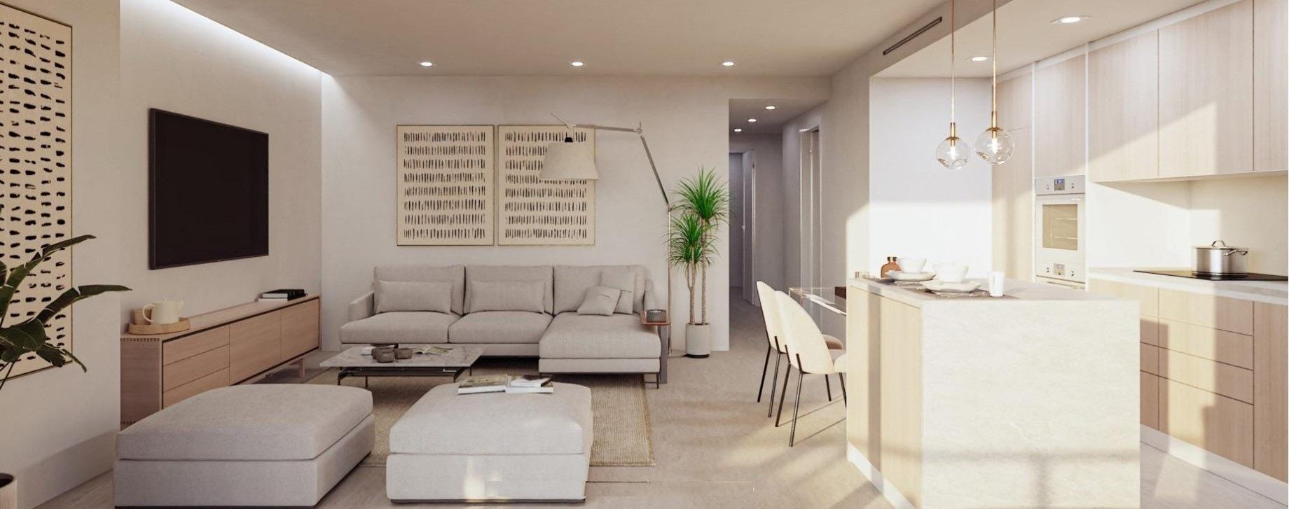 Open-plan living room with a sofa, dining table and adjoining white kitchen in Sierra Cortina, Alicante