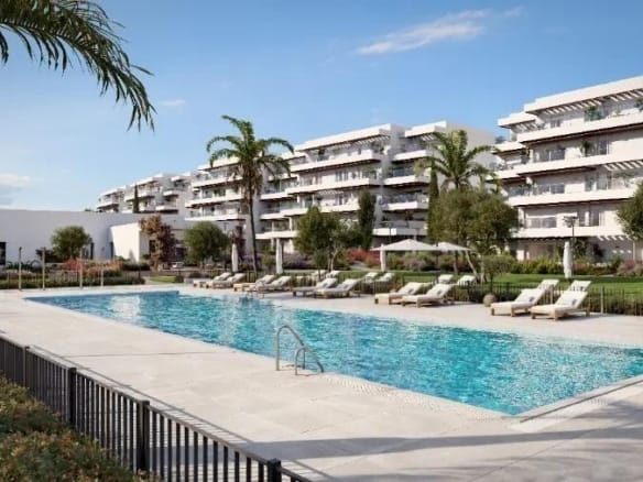 Communal swimming pool with sun loungers in front of modern apartment buildings in El Verger, Alicante