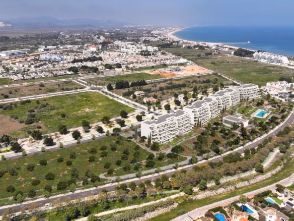 Aerial view of the apartment complex near the coastline and surrounding neighbourhood