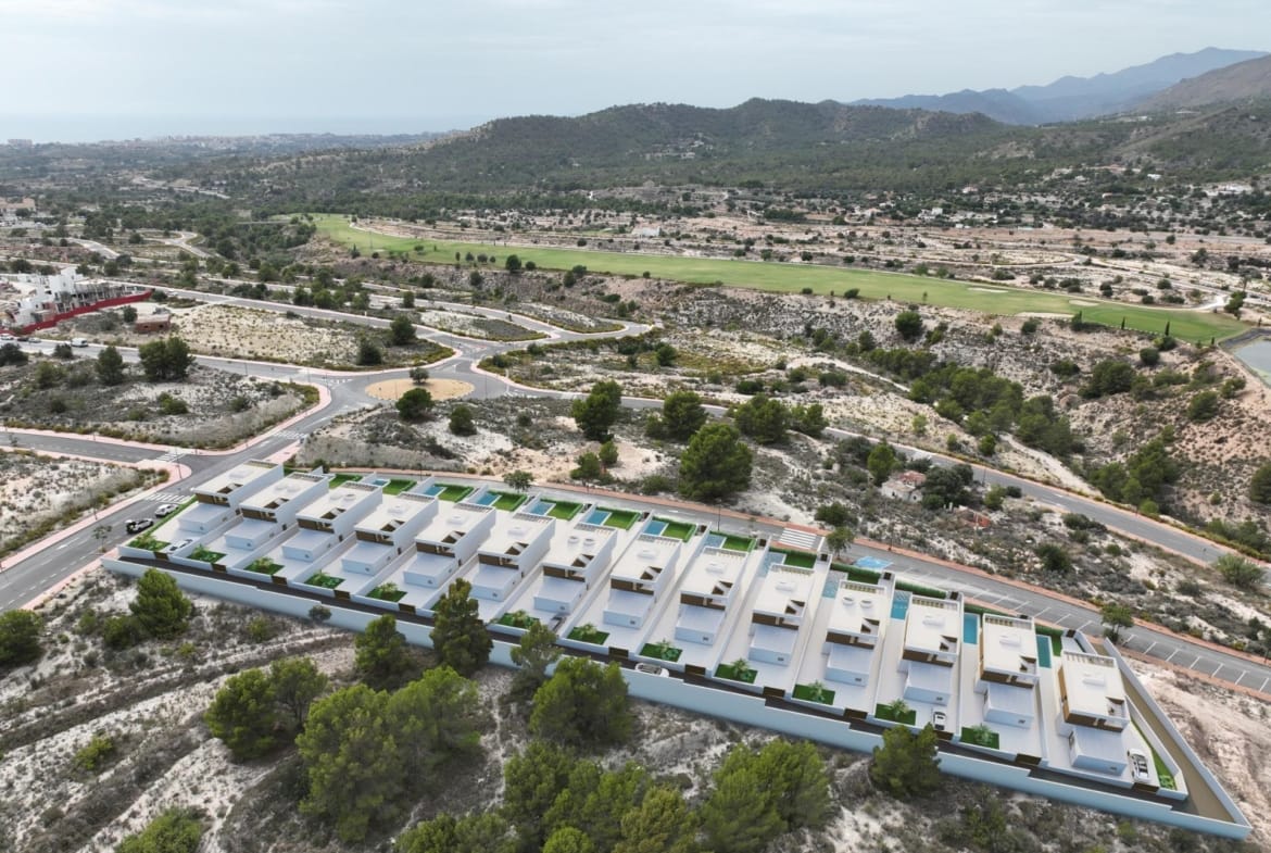 Aerial development rendering showing villas beside the surrounding hills and golf course in Puig Campana Golf, Finestrat, Alicante