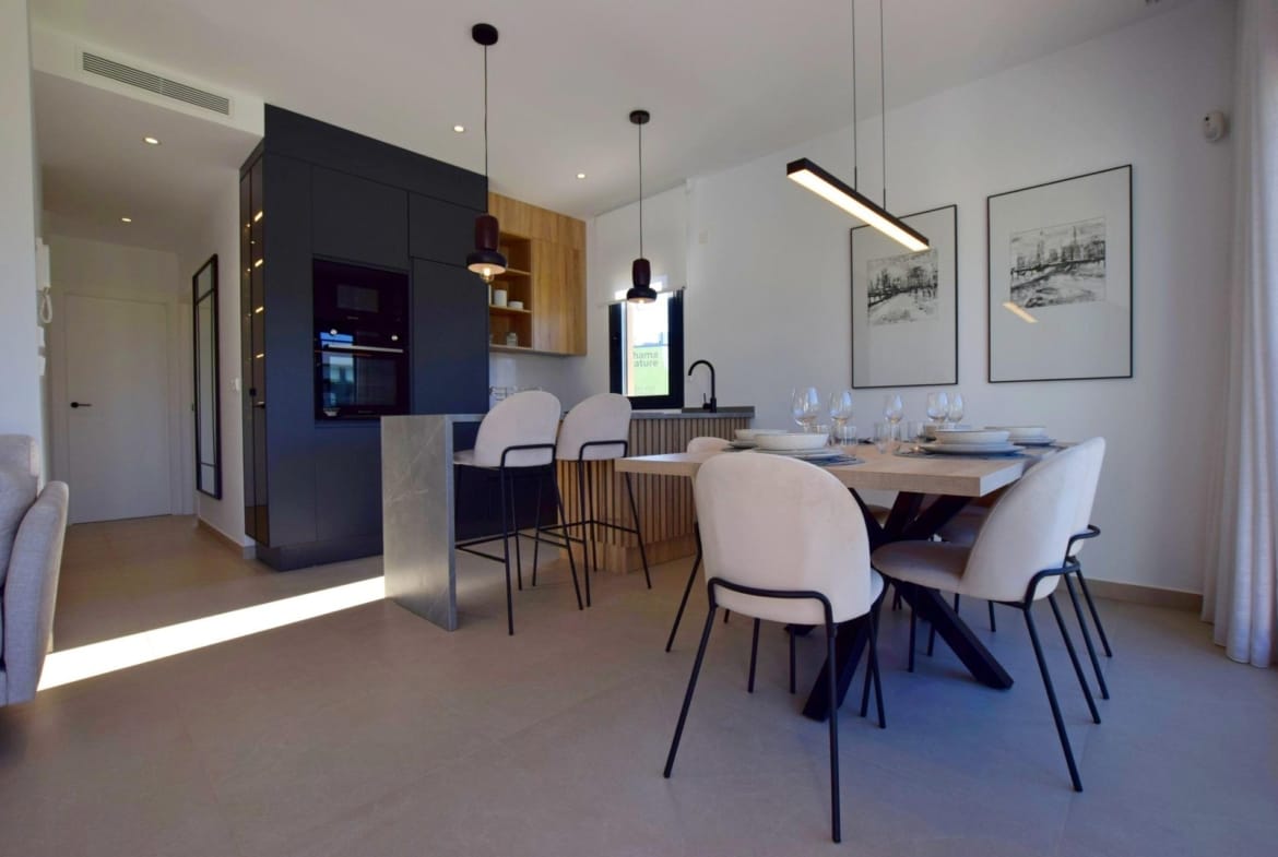 Dining space and kitchen with breakfast bar and pendant lighting