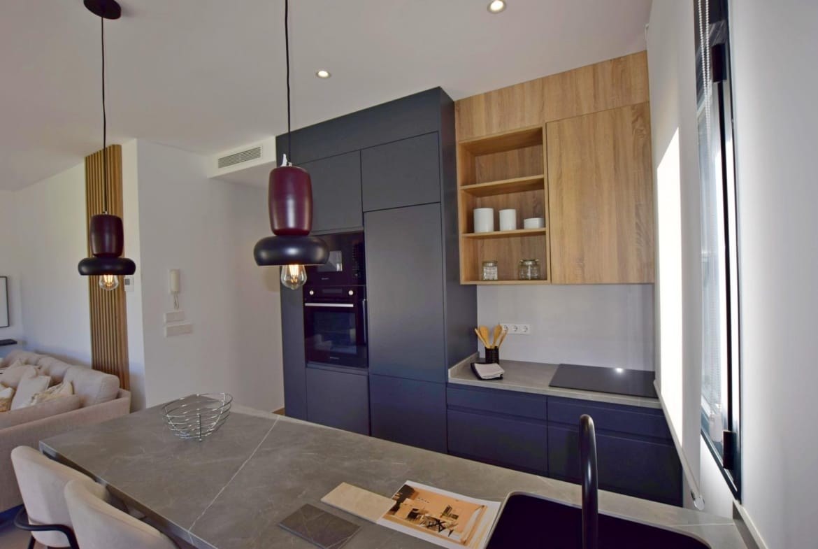 Modern fitted kitchen with dark cabinets and stone-look island