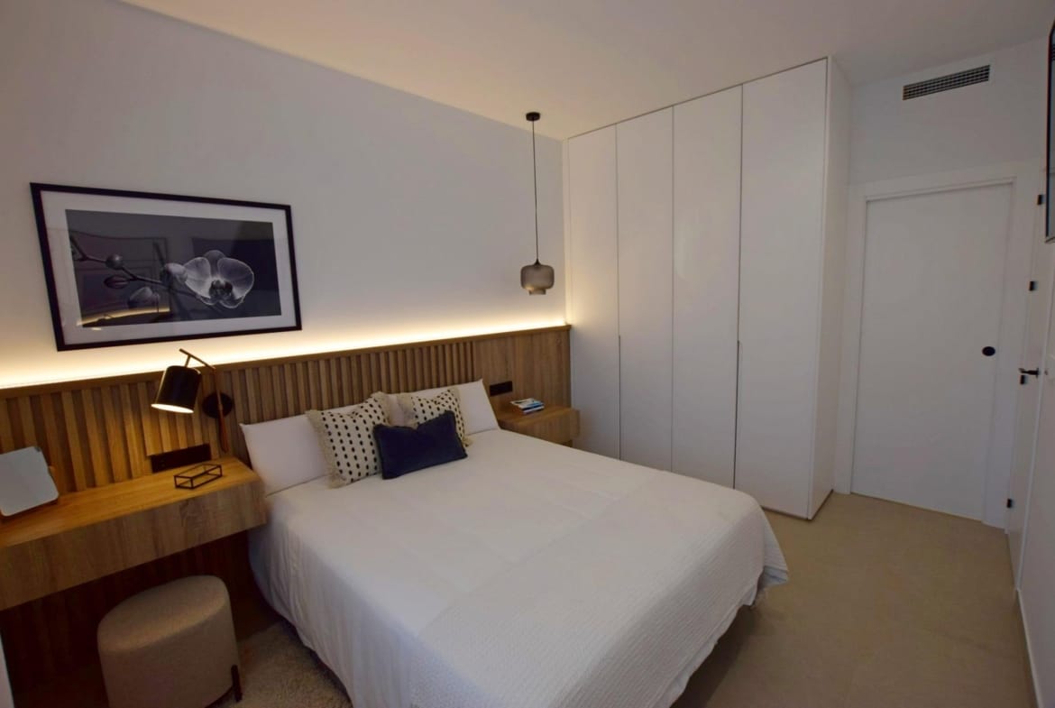 Bedroom with built-in wardrobes and warm wood finishes