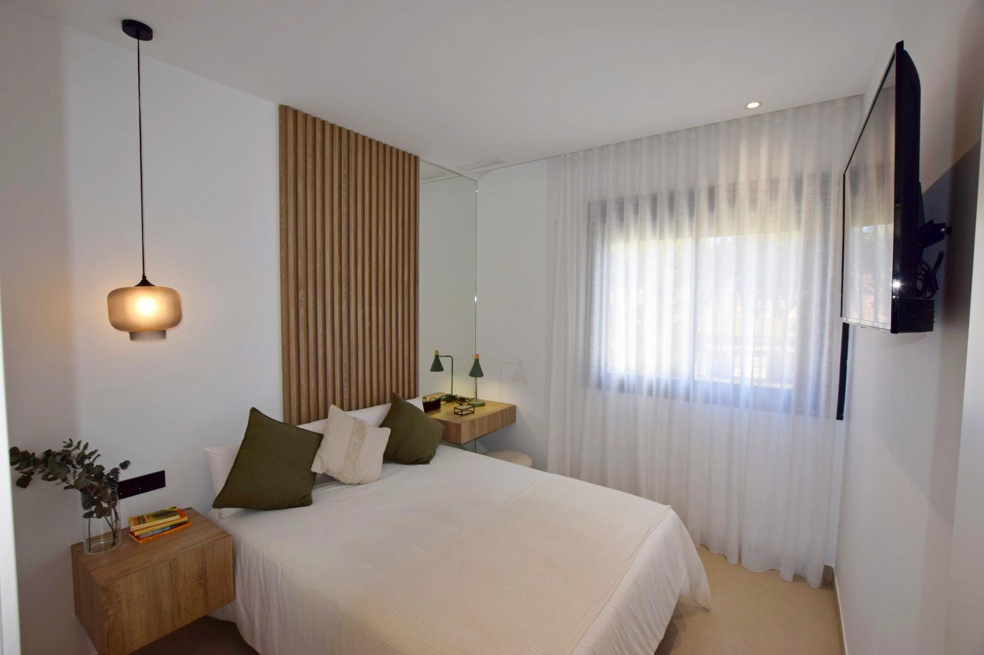 NEW-BUILD-APARTMENTS-IN-CONDADO-DE-ALHAMA-GOLF-COURSE-17 Bedroom with double bed, wall-mounted television and window
