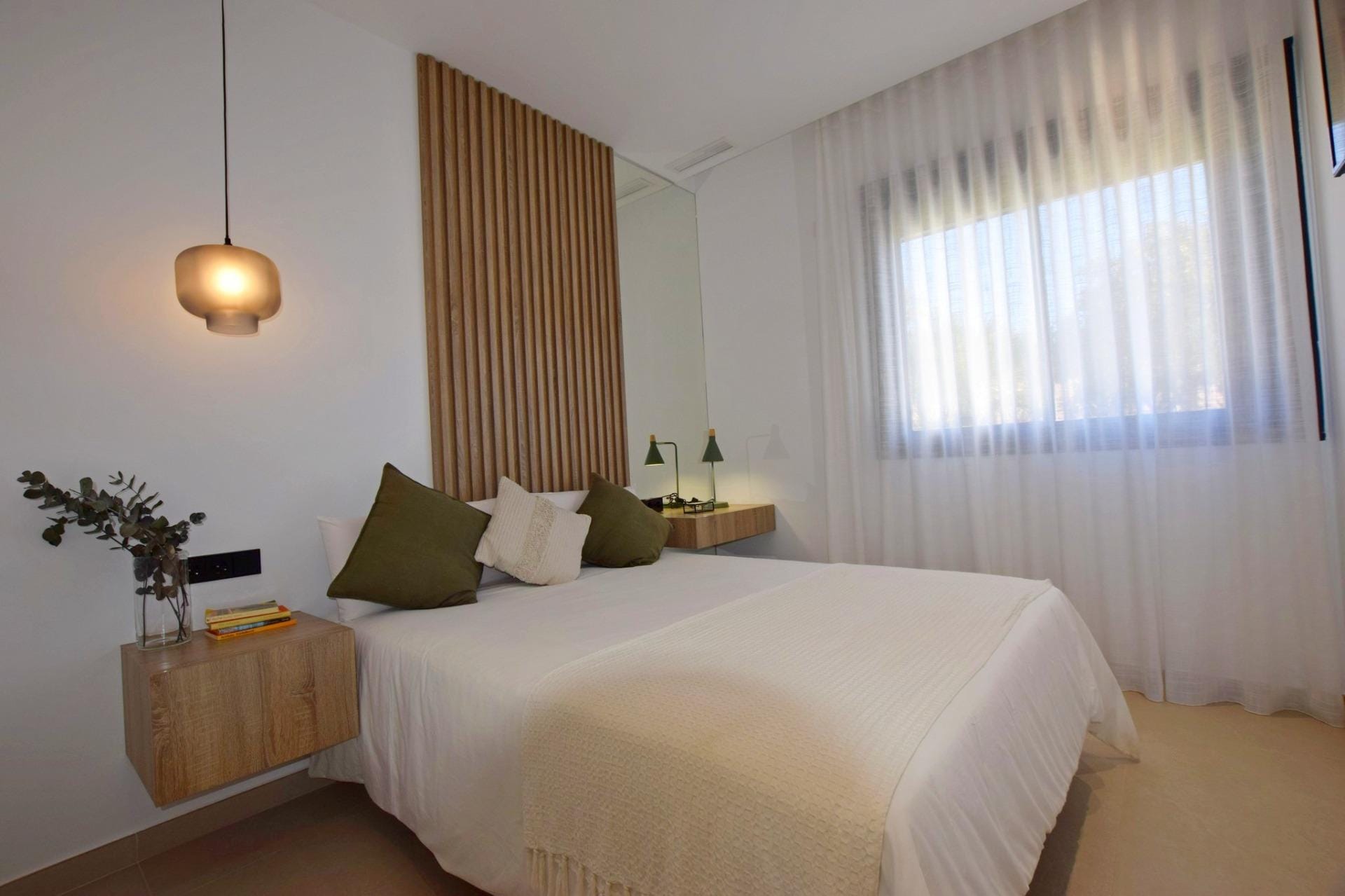 NEW-BUILD-APARTMENTS-IN-CONDADO-DE-ALHAMA-GOLF-COURSE-18 Bedroom with floating bedside tables and soft natural light