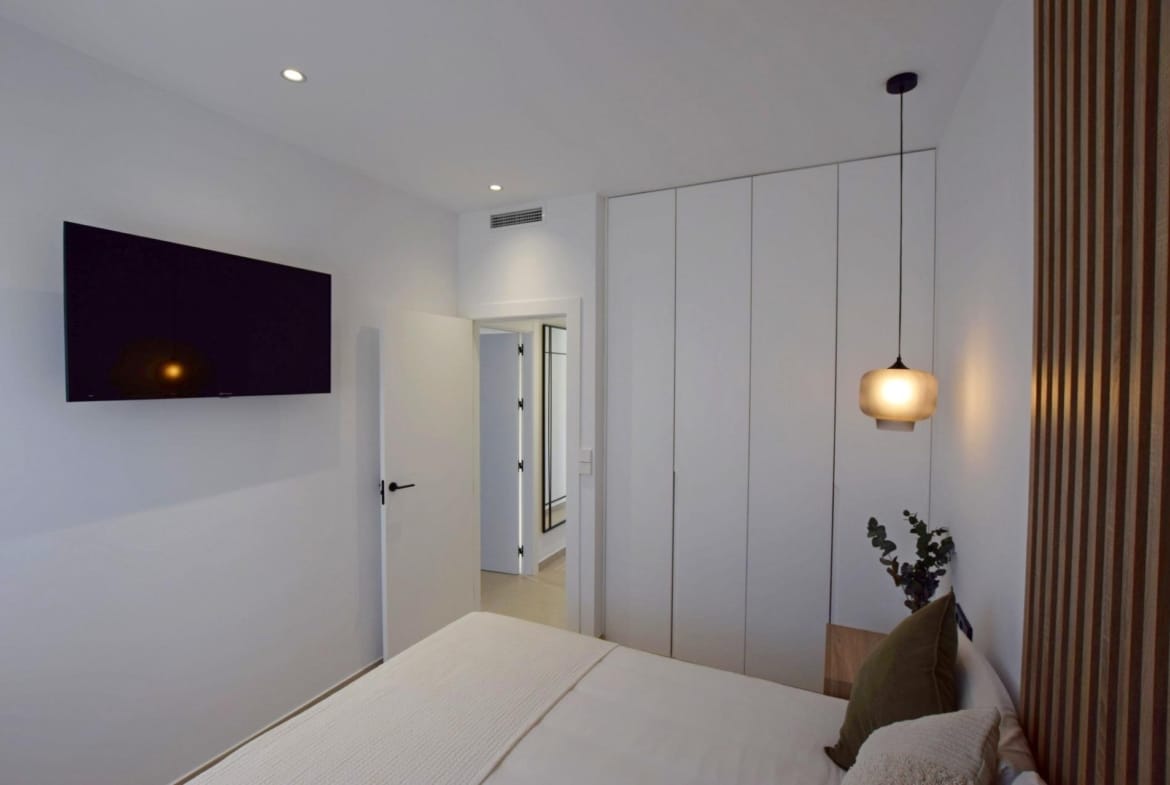 Bedroom with fitted wardrobes and pendant lighting