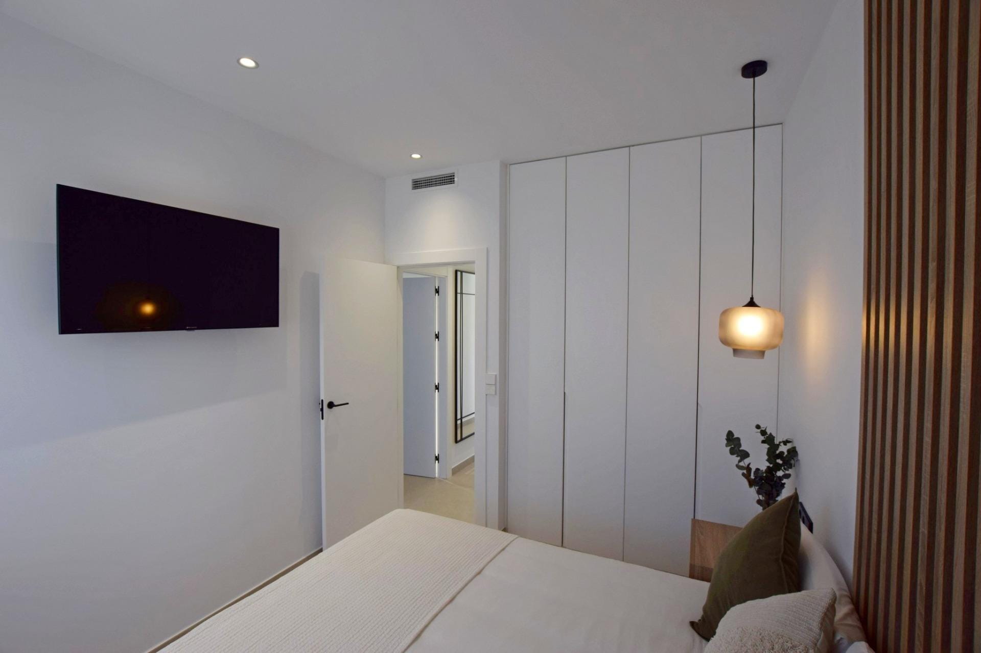 NEW-BUILD-APARTMENTS-IN-CONDADO-DE-ALHAMA-GOLF-COURSE-19 Bedroom with fitted wardrobes and pendant lighting