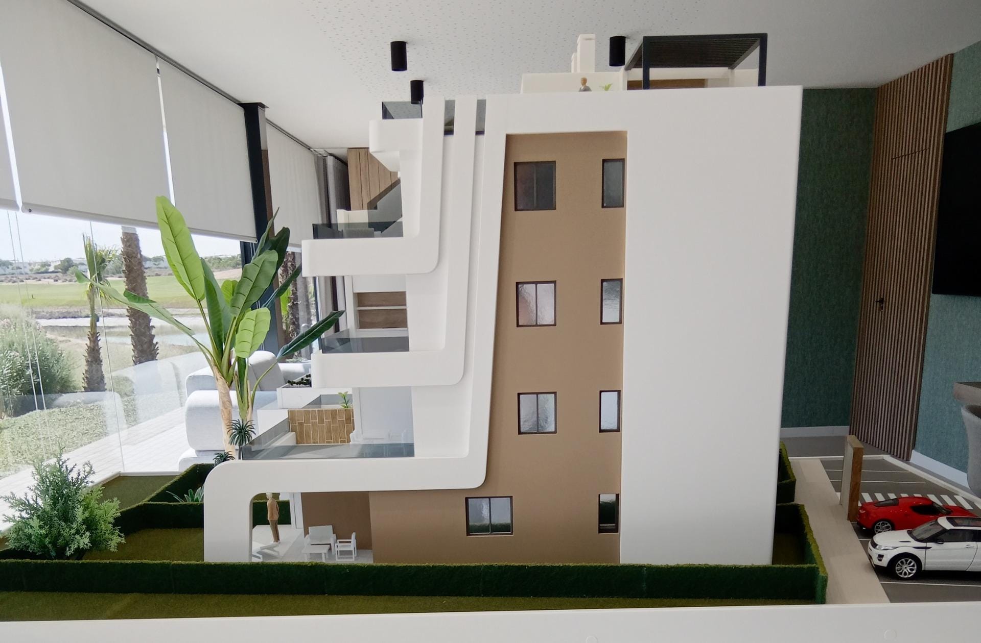 NEW-BUILD-APARTMENTS-IN-CONDADO-DE-ALHAMA-GOLF-COURSE-2 Side view of the apartment building scale model with parking area