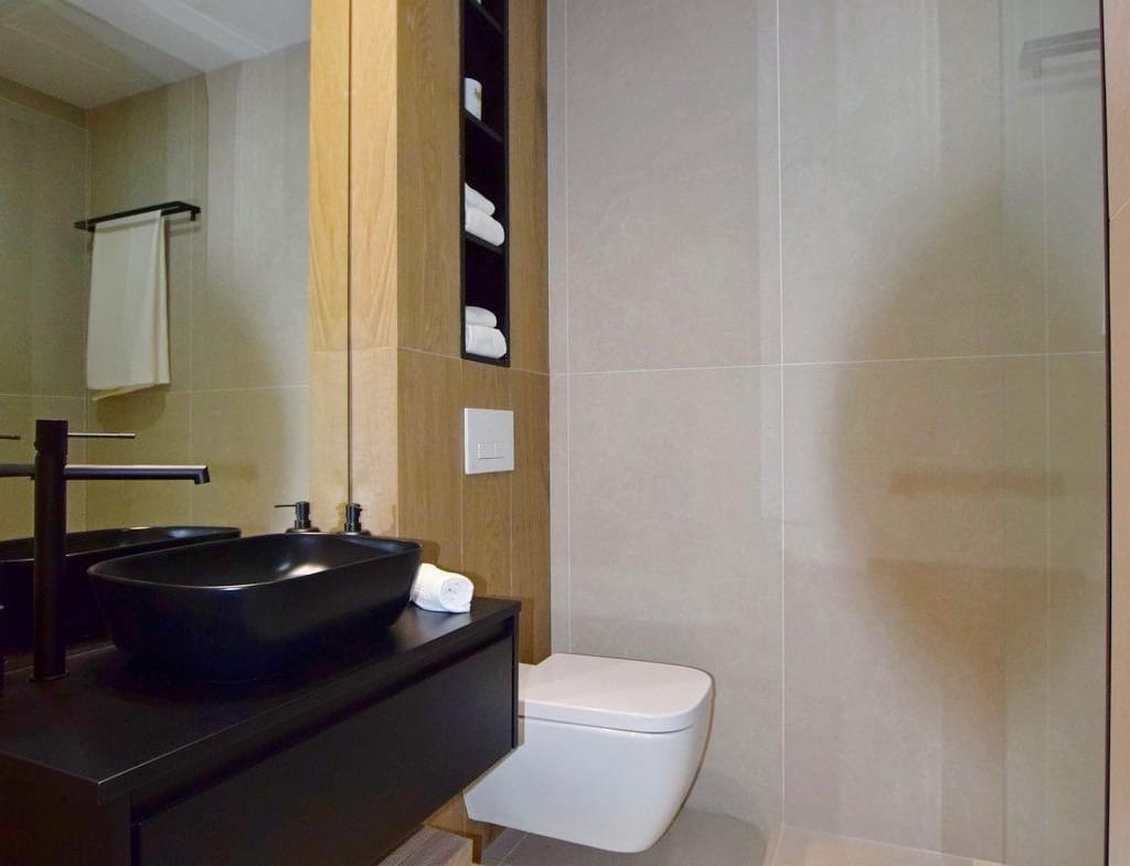 Stylish bathroom with black basin and walk-in shower