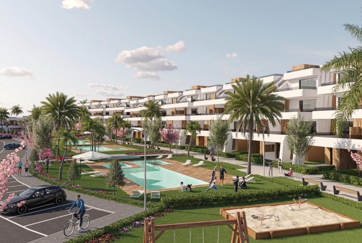 Communal pools and landscaped gardens in front of modern apartments