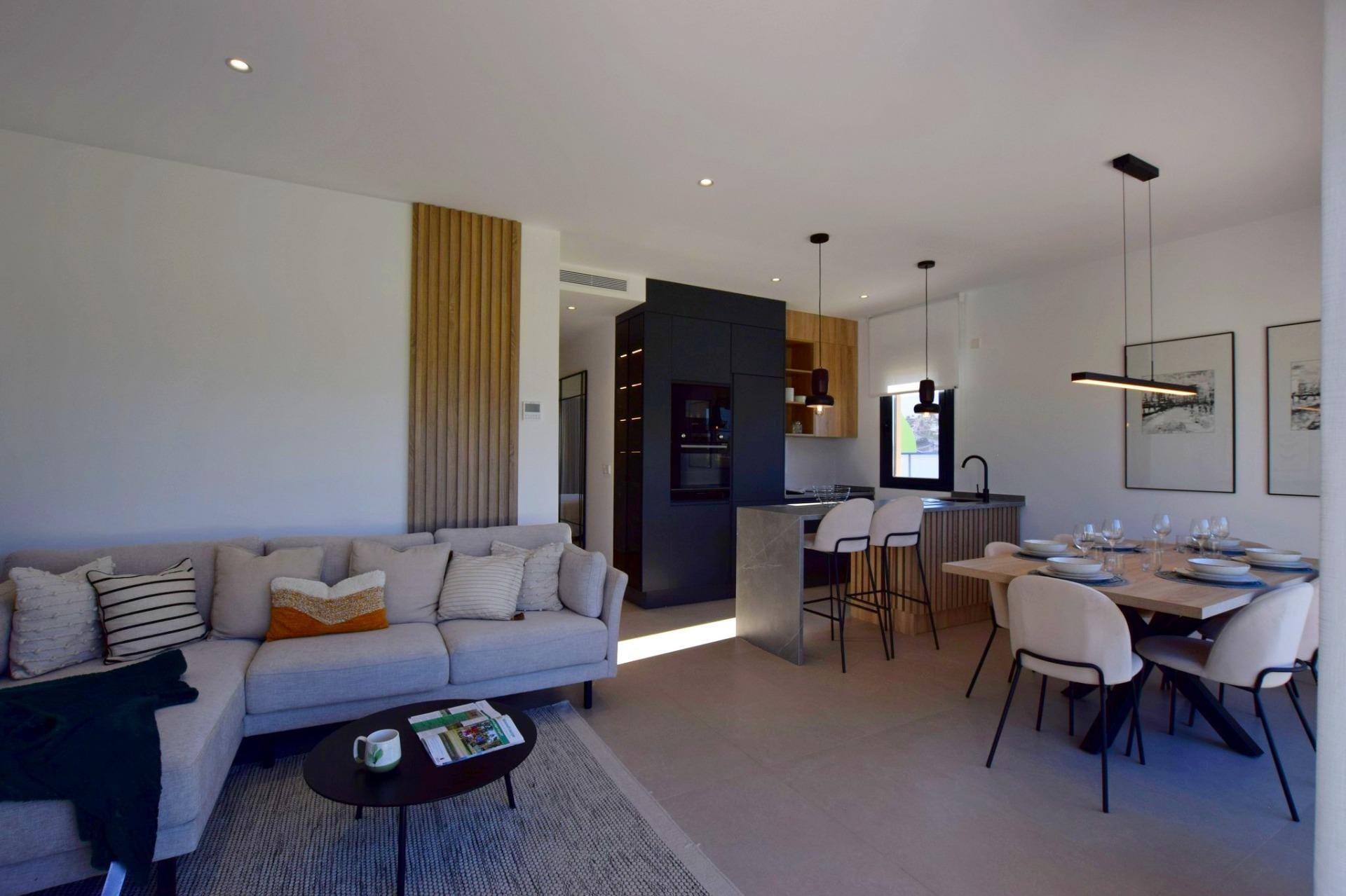 NEW-BUILD-APARTMENTS-IN-CONDADO-DE-ALHAMA-GOLF-COURSE-6 Open-plan living and dining room with kitchen island