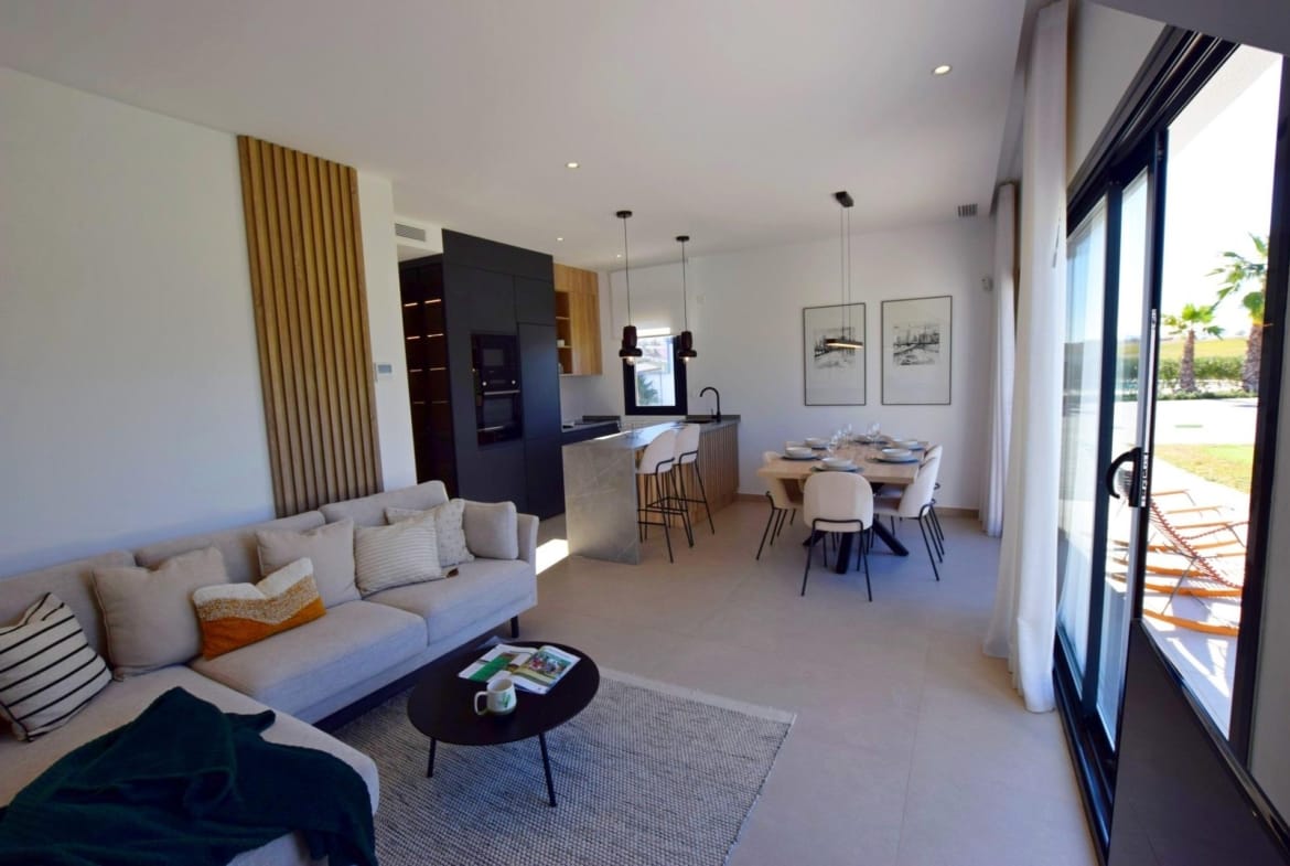 Bright open-plan living area with dining space and sliding doors