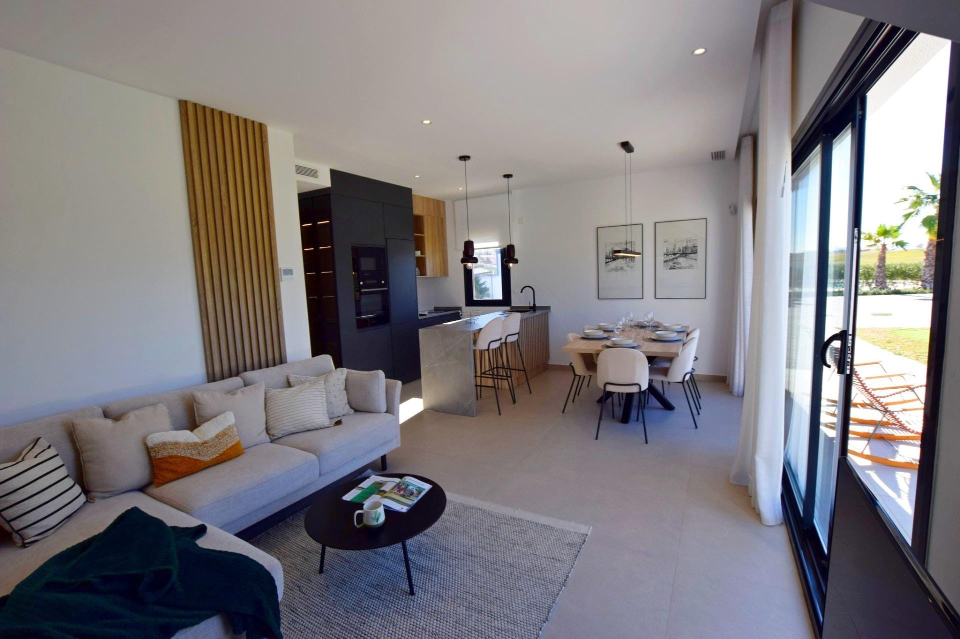 NEW-BUILD-APARTMENTS-IN-CONDADO-DE-ALHAMA-GOLF-COURSE-7 Bright open-plan living area with dining space and sliding doors