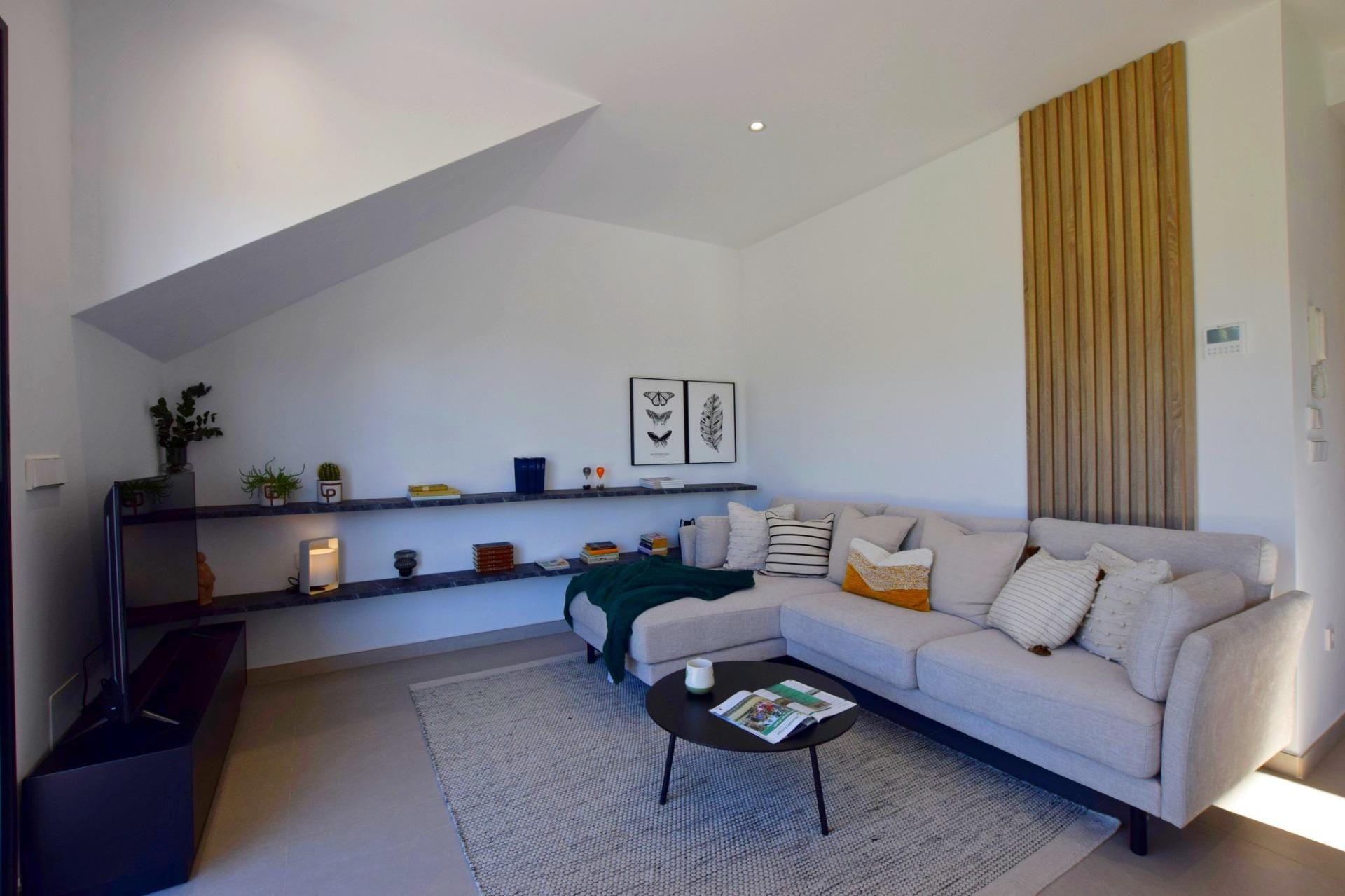 NEW-BUILD-APARTMENTS-IN-CONDADO-DE-ALHAMA-GOLF-COURSE-8 Contemporary living room with sectional sofa and built-in shelving
