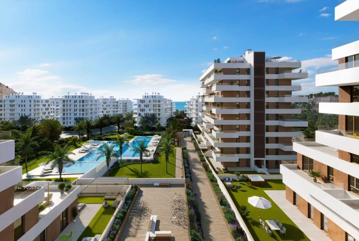 Apartment buildings surrounding pools and landscaped walkways in Playa del Torres, Villajoyosa, Alicante