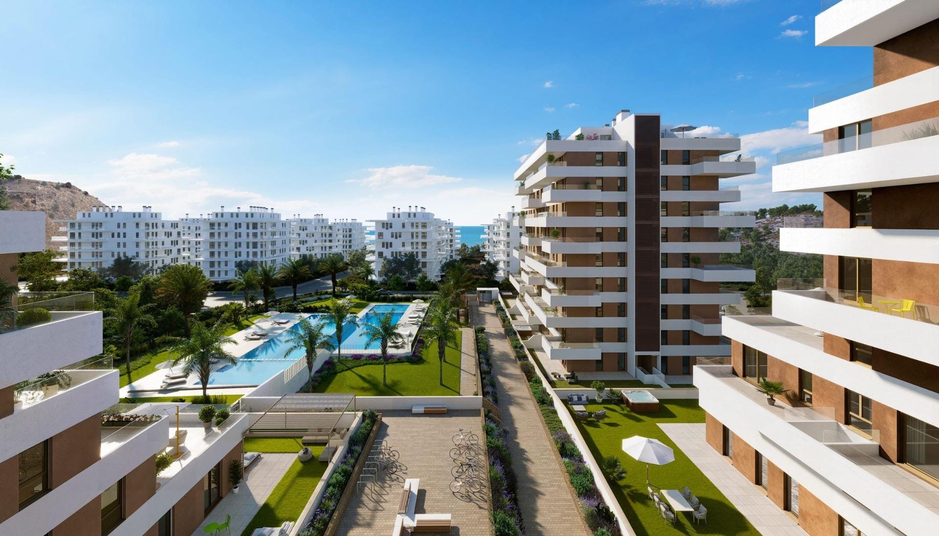 Apartment buildings surrounding pools and landscaped walkways in Playa del Torres, Villajoyosa, Alicante