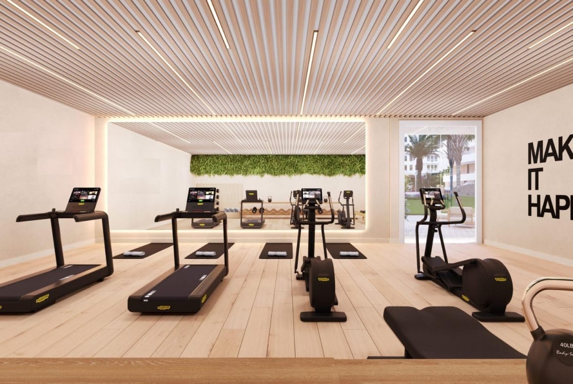 Gym with treadmills, exercise machines and a mirrored wall in Playa del Torres, Villajoyosa, Alicante