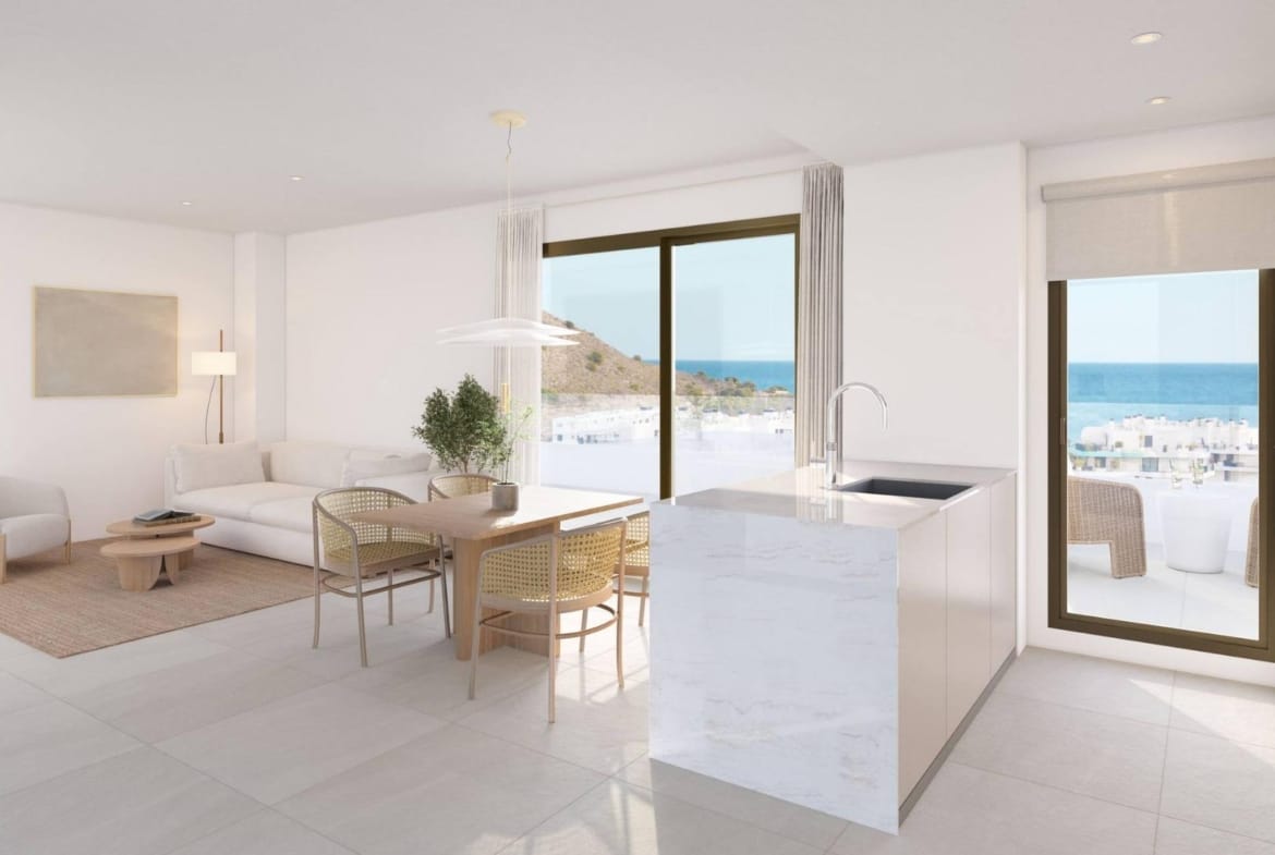 Kitchen island beside the dining area and terrace doors in Playa del Torres, Villajoyosa, Alicante