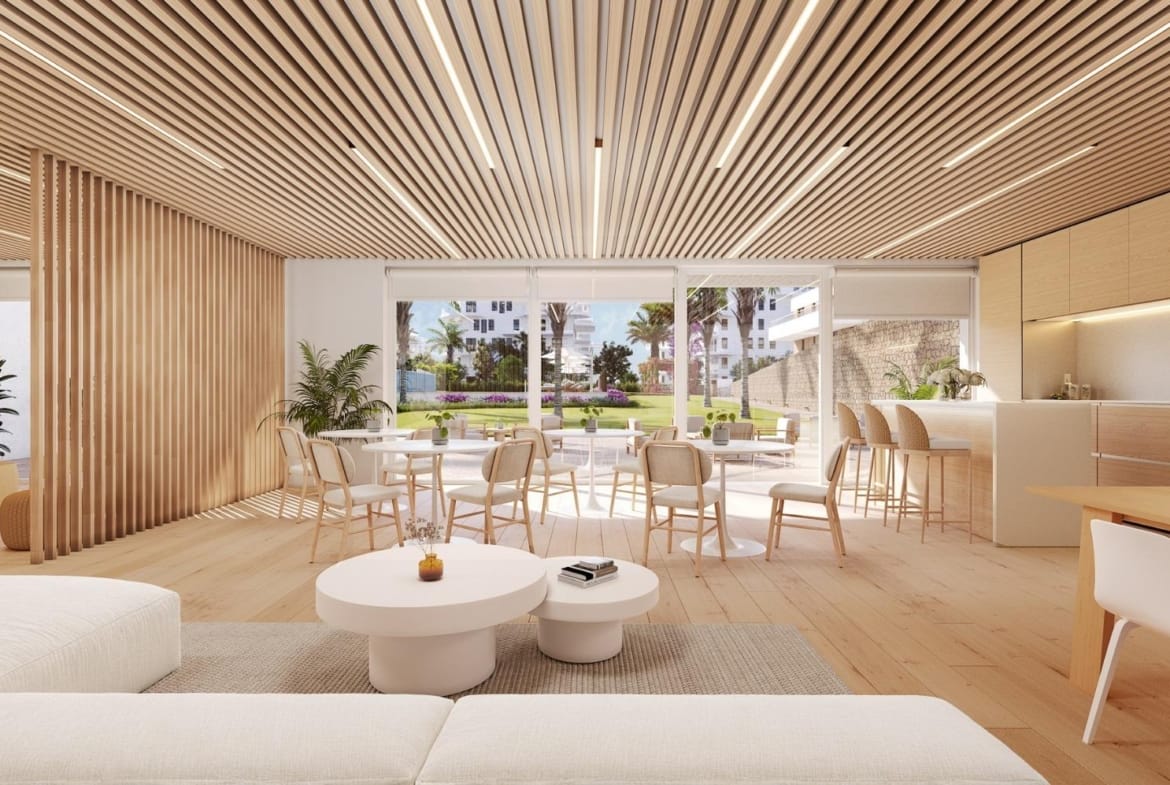 Social club lounge with dining tables and a kitchen area in Playa del Torres, Villajoyosa, Alicante
