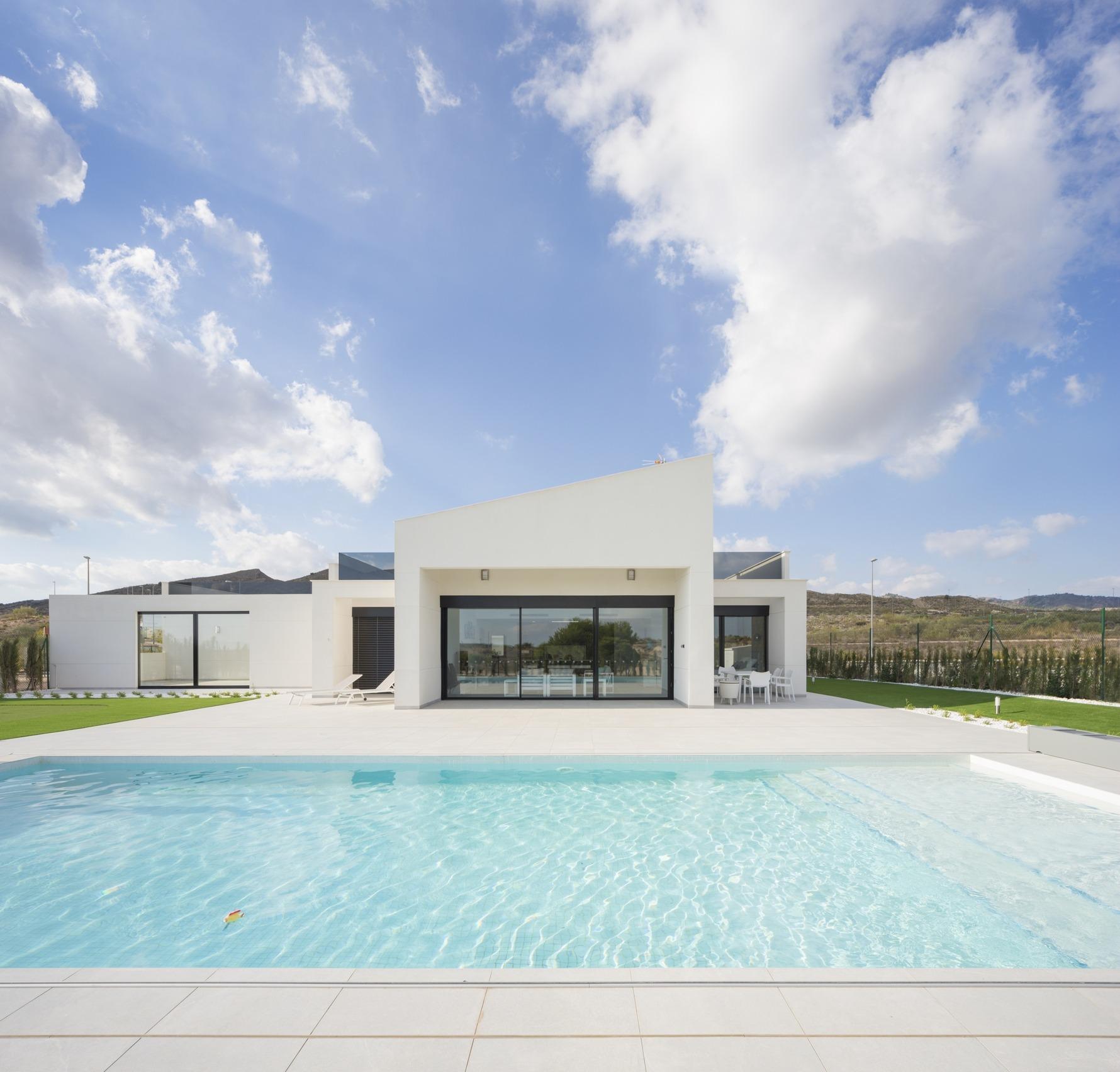 Front-facing render of single-storey villa with large terrace and pool in the foreground