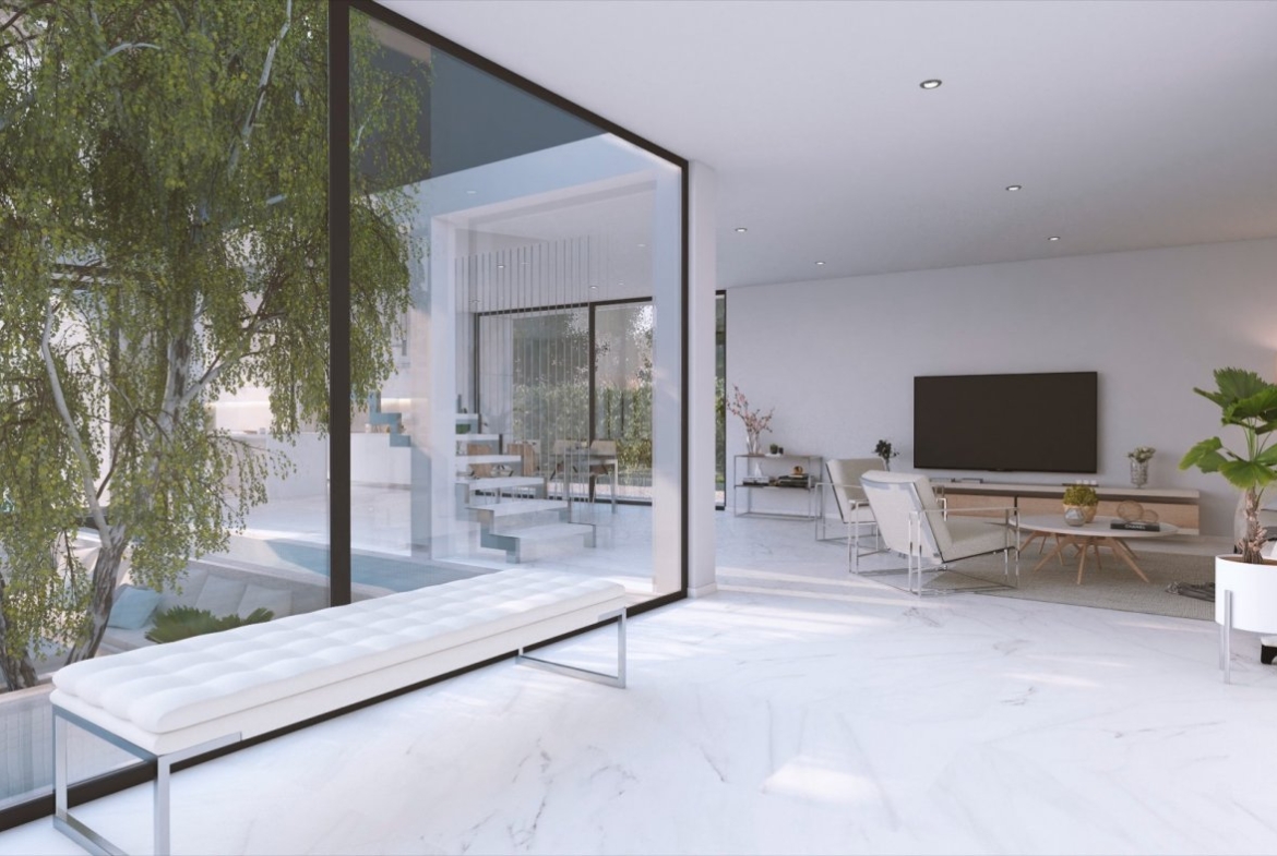 Interior view with a cushioned bench by floor-to-ceiling window opening onto the living room and stairs