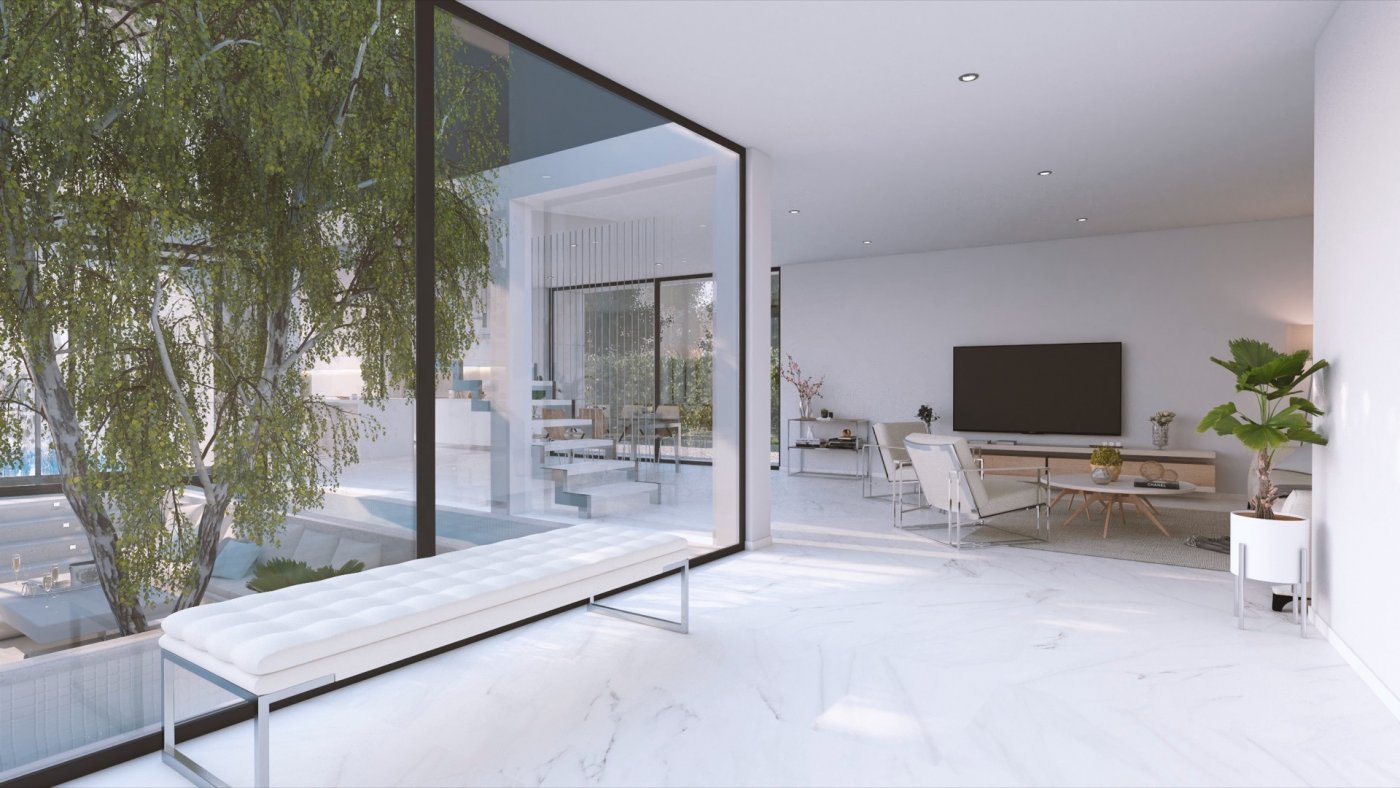 Interior view with a cushioned bench by floor-to-ceiling window opening onto the living room and stairs