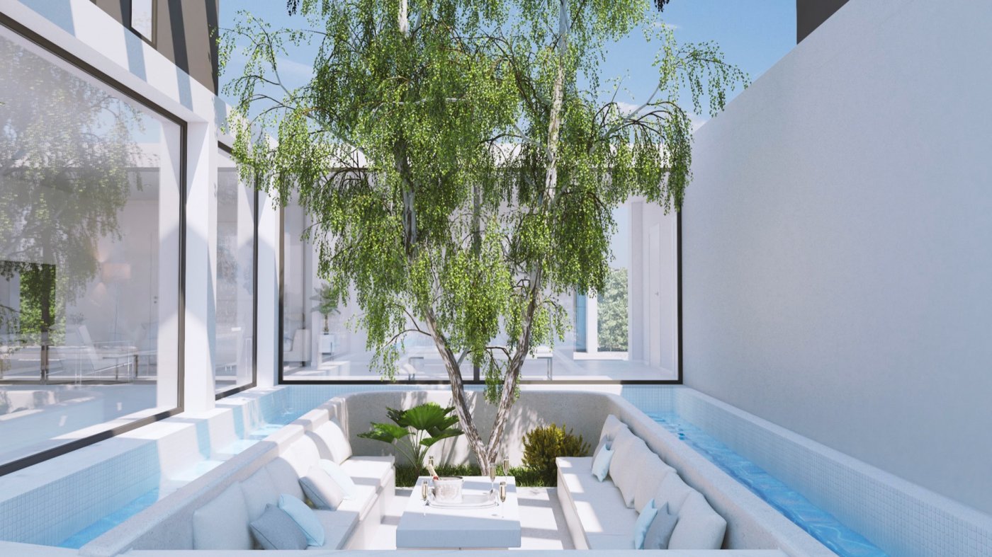 Sunken outdoor seating courtyard surrounding a small tree with water channel feature