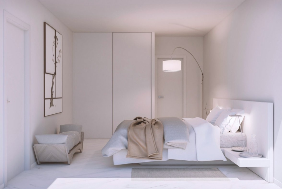 Neutral bedroom showing large built-in wardrobes, bedside pendant light and armchair