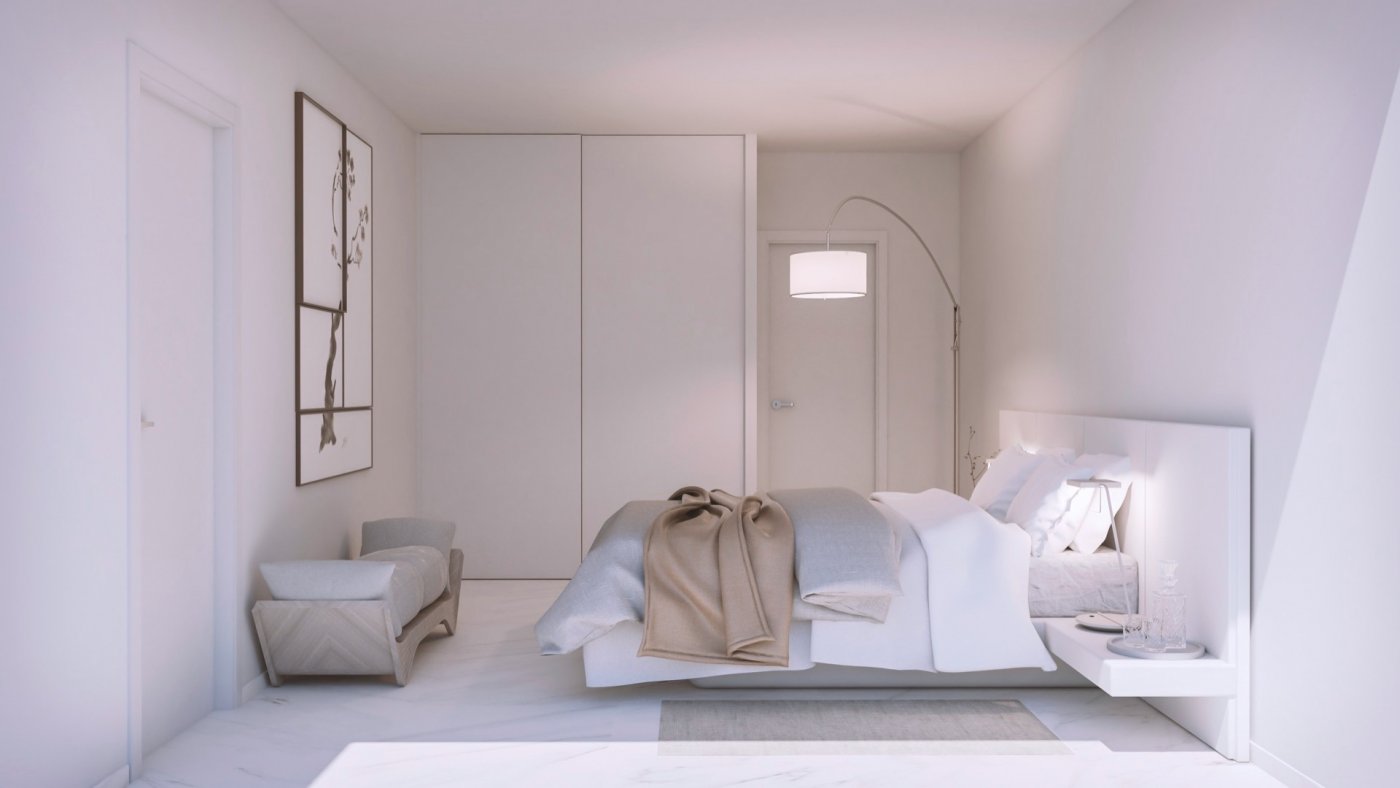 Neutral bedroom showing large built-in wardrobes, bedside pendant light and armchair