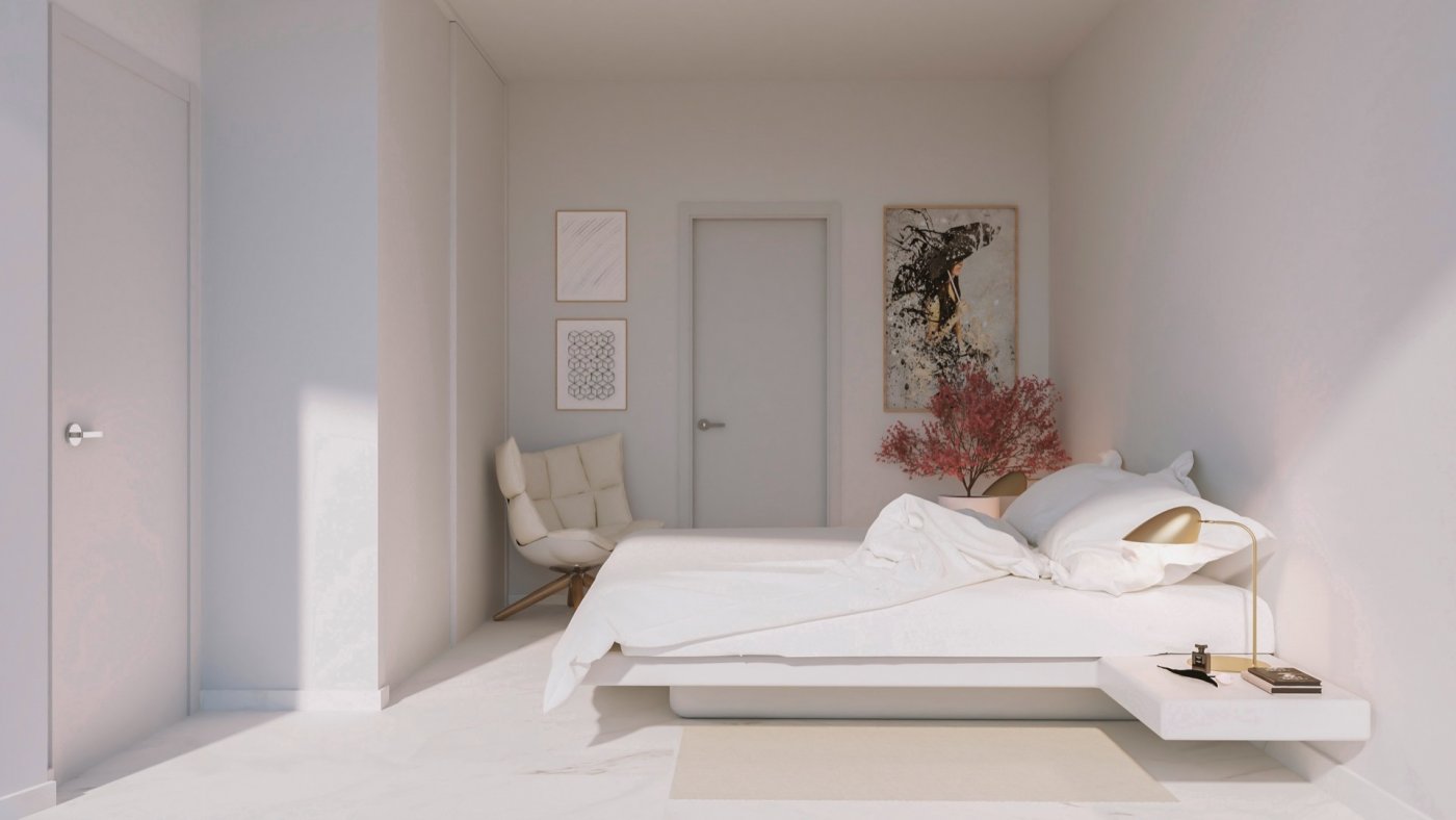 Minimal bedroom with low platform bed, accent chair and framed abstract wall art