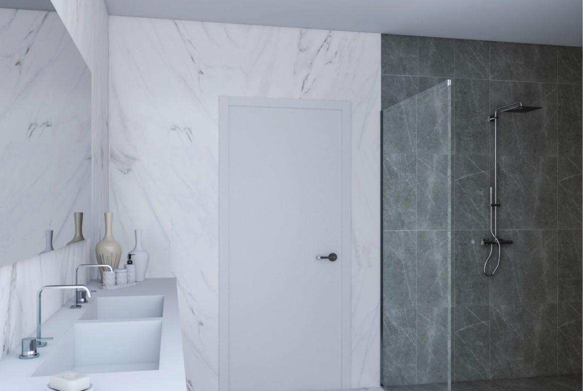 Bathroom with illuminated round mirror, floating vanity, wall-hung toilet and tiled shower