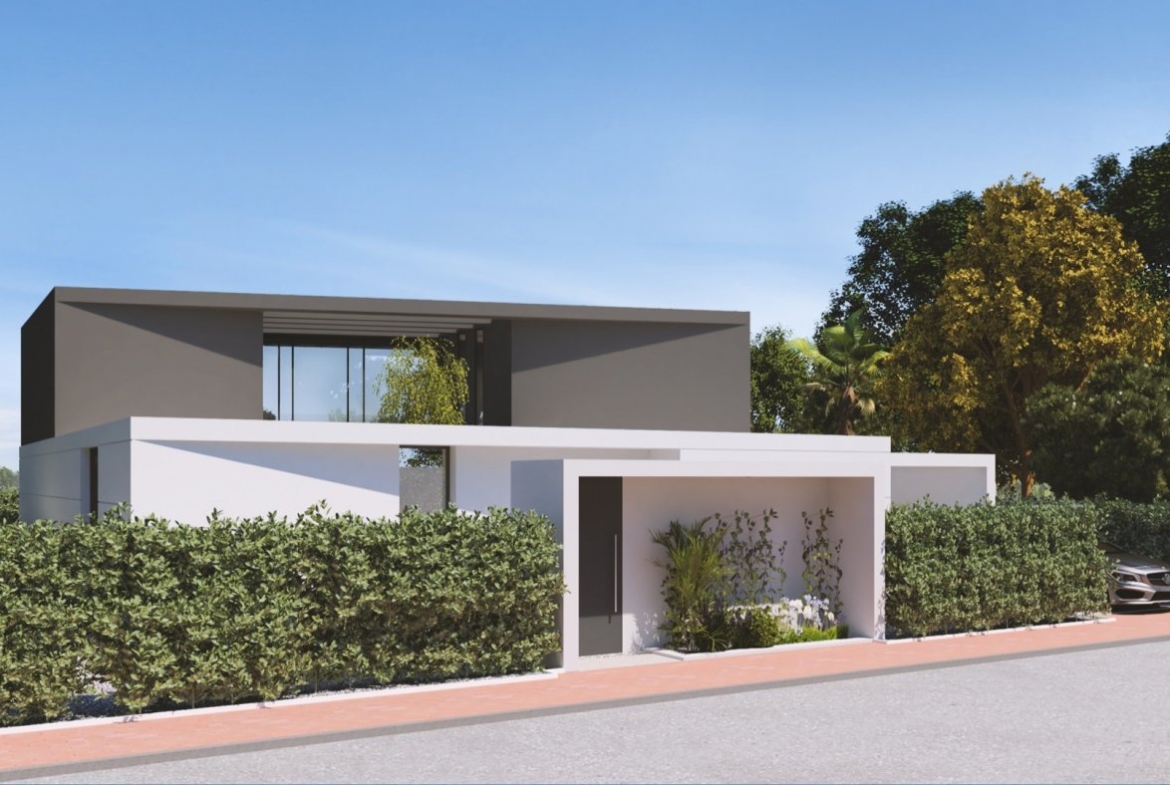 Angled street view of two-storey villa with driveway gate, entrance alcove and tall hedging