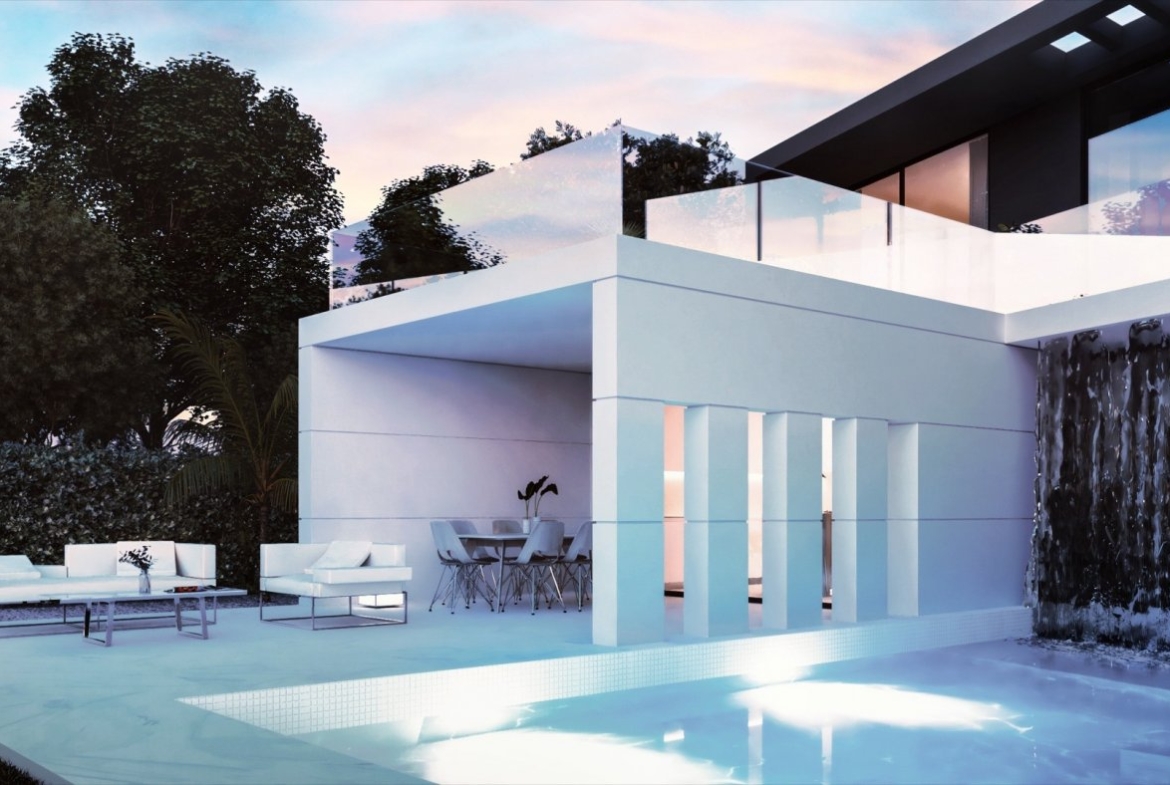 Dusk view of illuminated pool and waterfall feature with outdoor lounge and covered dining area