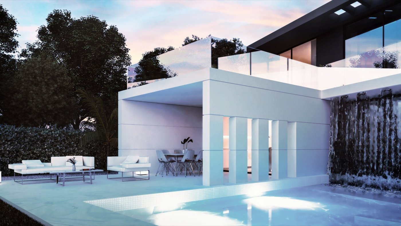 Dusk view of illuminated pool and waterfall feature with outdoor lounge and covered dining area