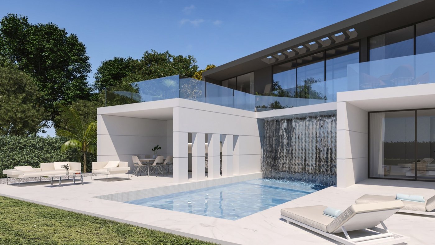 Poolside close-up showing waterfall feature, shaded dining area and two sun loungers on terrace