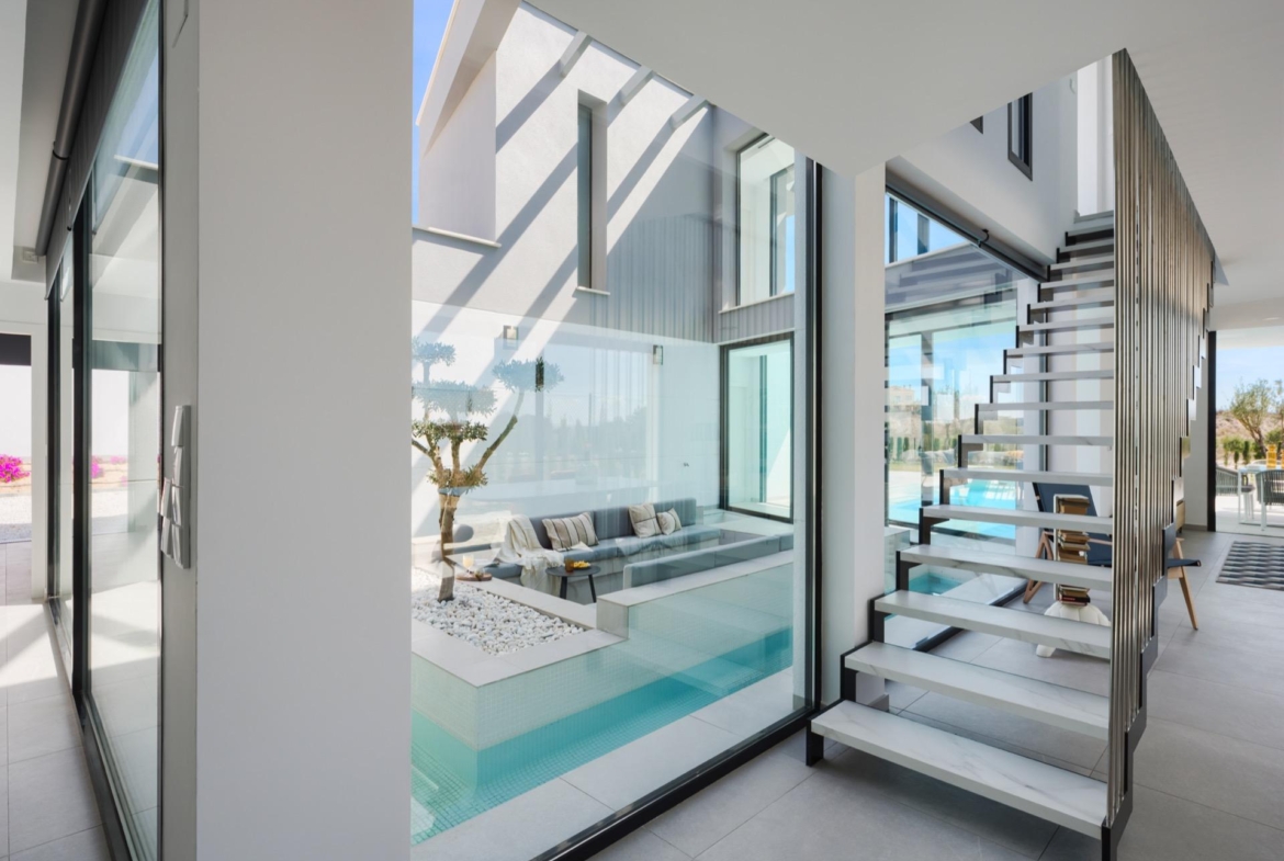 Interior atrium render featuring a recessed seating area surrounded by a narrow water channel and stairs