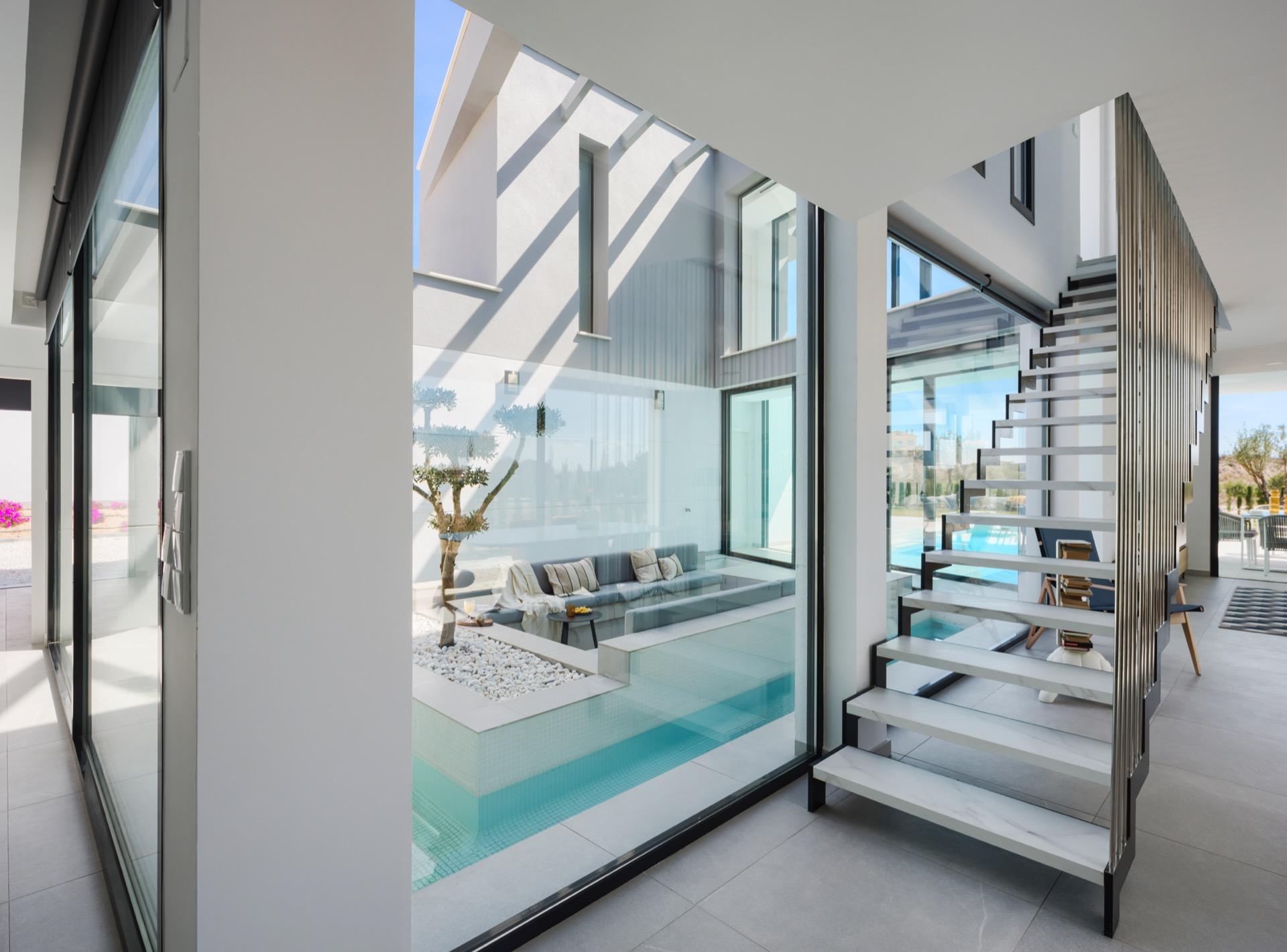 Interior atrium render featuring a recessed seating area surrounded by a narrow water channel and stairs