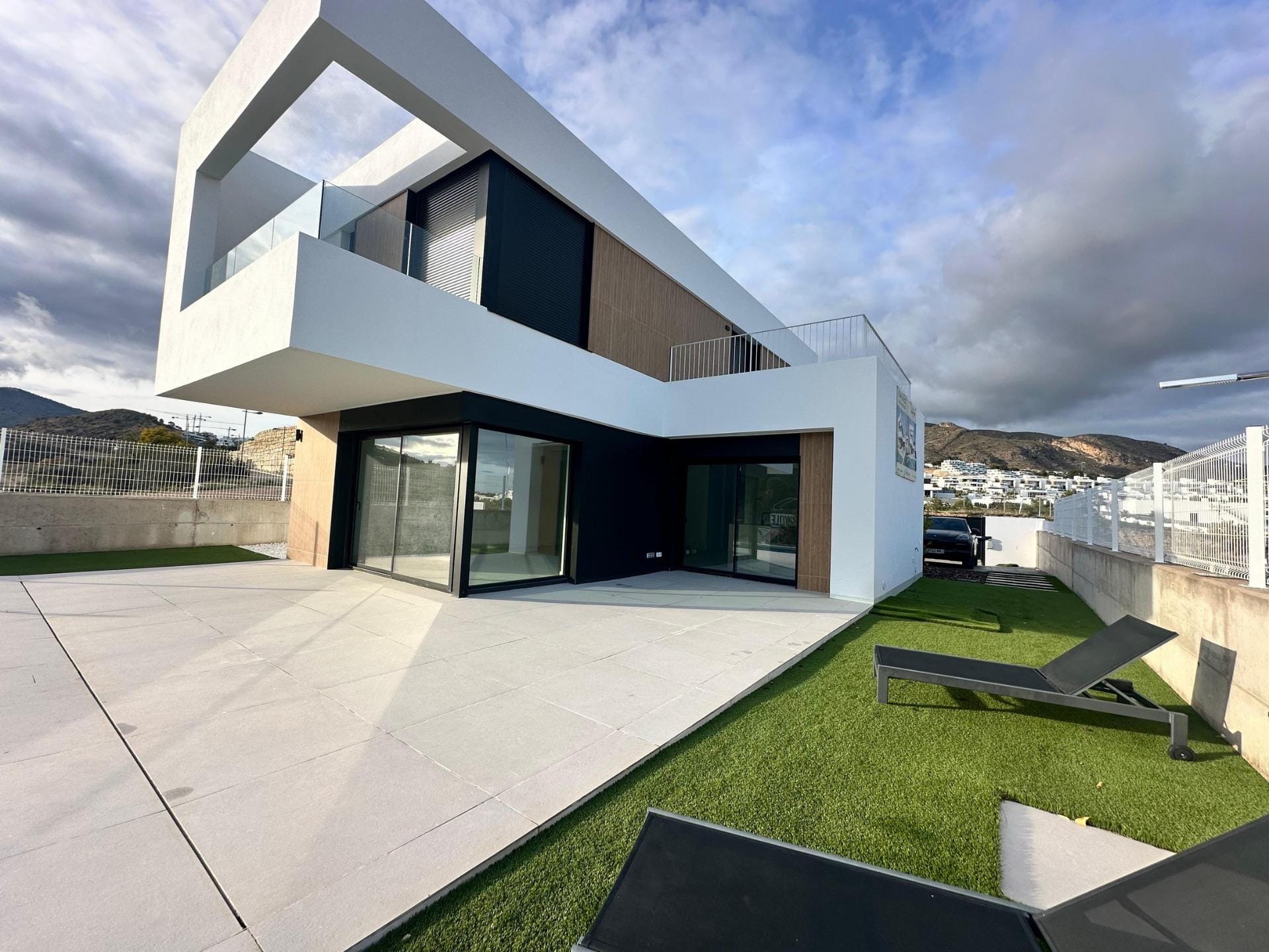Villa exterior with a covered terrace and landscaped garden in Finestrat, Alicante