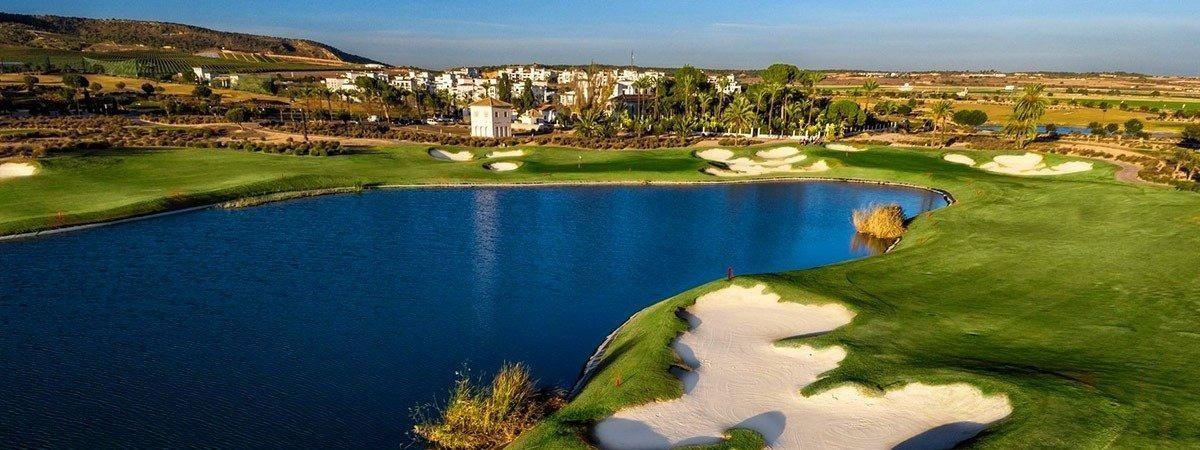 Aerial view of golf course lake, sand bunkers and clubhouse buildings beyond the fairway