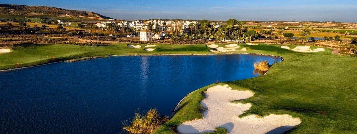 Aerial view of golf course lake, sand bunkers and clubhouse buildings beyond the fairway