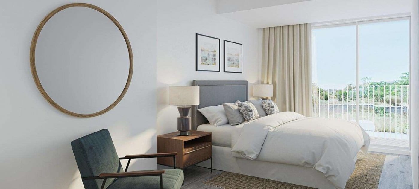 Rendering of a double bedroom with a green armchair, round wall mirror and glazed doors in Jávea, Alicante