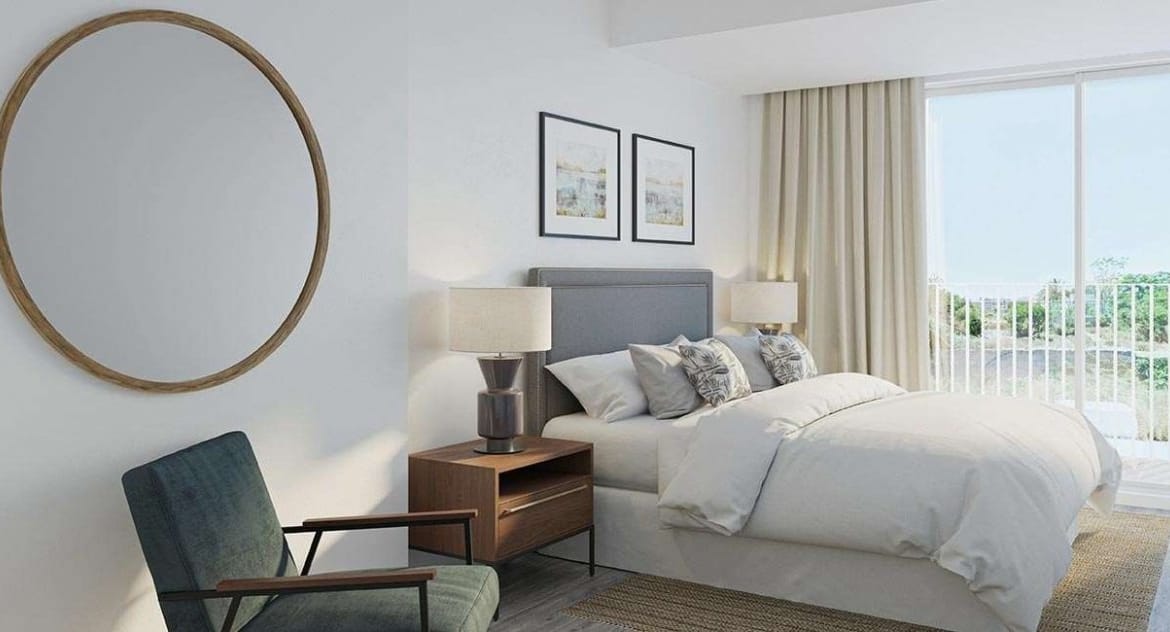 Rendering of a double bedroom with a green armchair, round wall mirror and glazed doors in Jávea, Alicante
